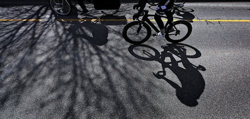 The shadows of bicycle riders and trees were cast on the pavement along W. River Pkwy.] JIM GEHRZ • james.gehrz@startribune.com /Minneapolis, MN / April 1, 2016 3:30 PM - BACKGROUND INFORMATION: Waiting to put the pedal to the Gold Medal….. The MSP Kickoff Ride 2016 for the 30 Days of Biking happens Saturday. April is the month where people are encouraged to ride their bikes every day of the month. The 11 am, folks will be gathered at Gold Medal Park, and then bike through the Twin Cities, and end with festivities later.