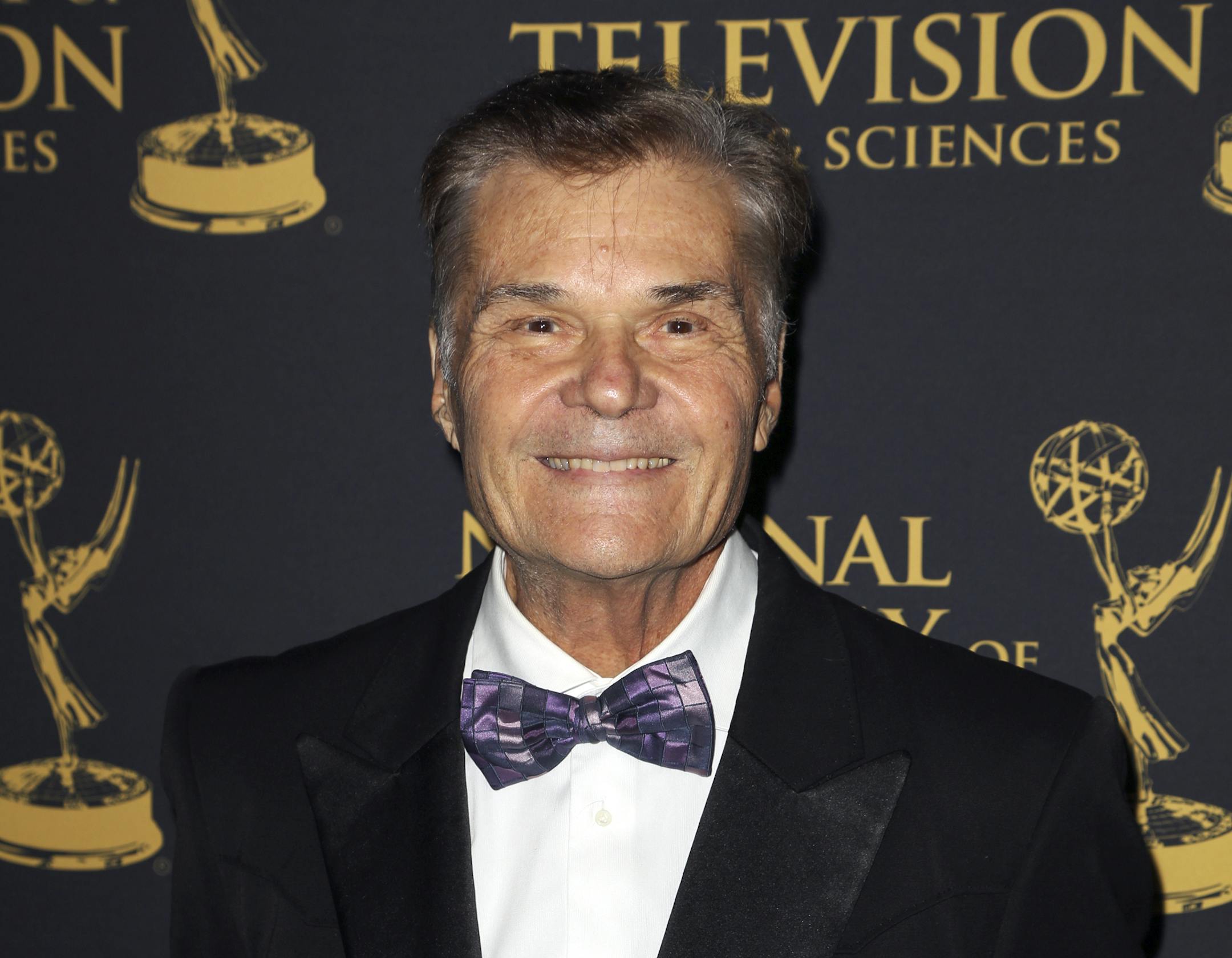 FILE - In this April 24, 2015, file photo, Fred Willard arrives at the 2015 Daytime Creative Arts Emmy Awards at The Universal Hilton, in Universal City, Calif. Willard, the comedic actor whose improv style kept him relevant for more than 50 years in films like "This Is Spinal Tap," "Best In Show" and "Anchorman," has died at age 86. Willard's daughter, Hope Mulbarger, said in a statement Saturday, May 16, 2020, that her father died peacefully Friday night. (Photo by Rich Fury/Invision/AP, File)