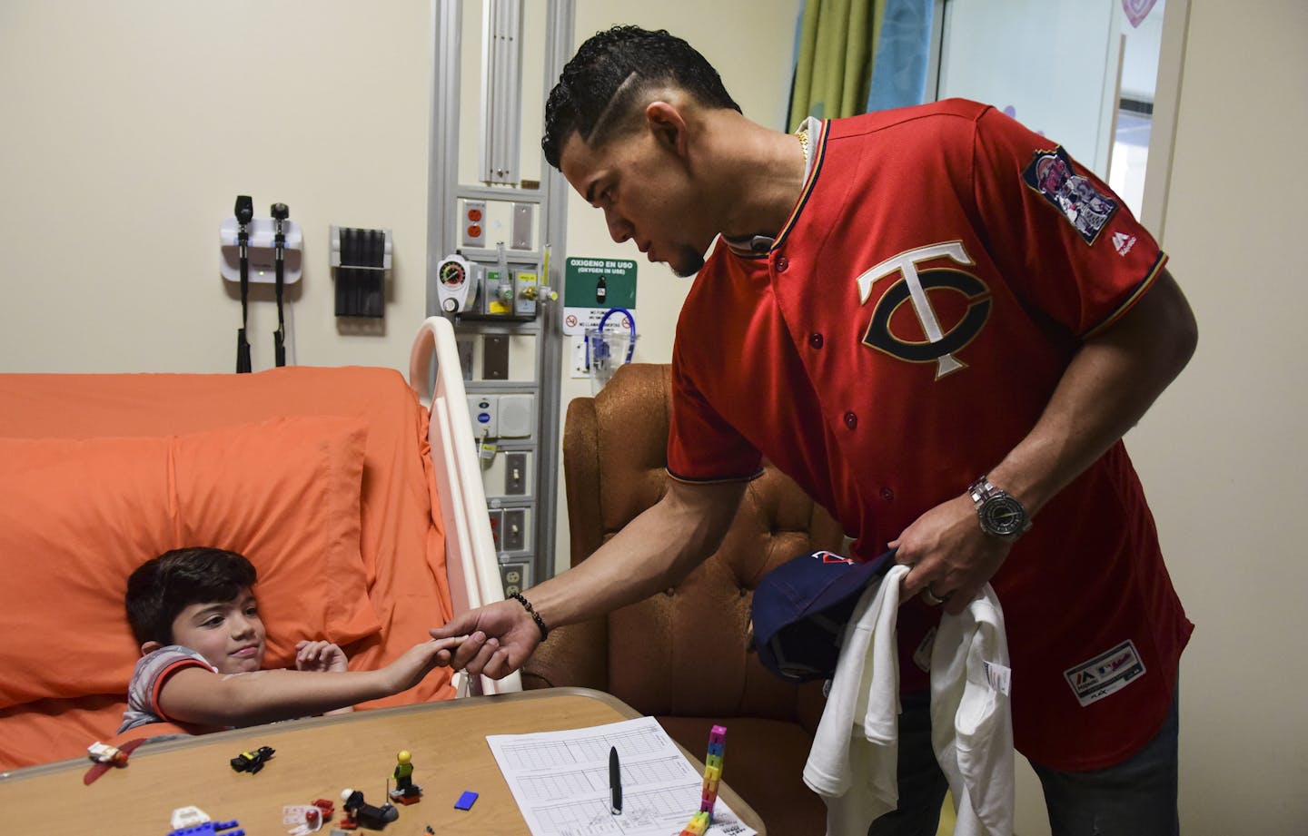 Minnesota Twins starting pitcher Jose Berrios shakes the hand of 7-year-old Lucas Suarez, during a visit by a group of Berrios' teammates at the San Jorge Children's Hospital in San Juan, Puerto Rico, Monday, April 16, 2018. Next Tuesday and Wednesday, the Cleveland Indians and the Minnesota Twins will meet in a two-game series at Hiram Bithorn Stadium in San Juan. (AP Photo/Carlos Giusti)