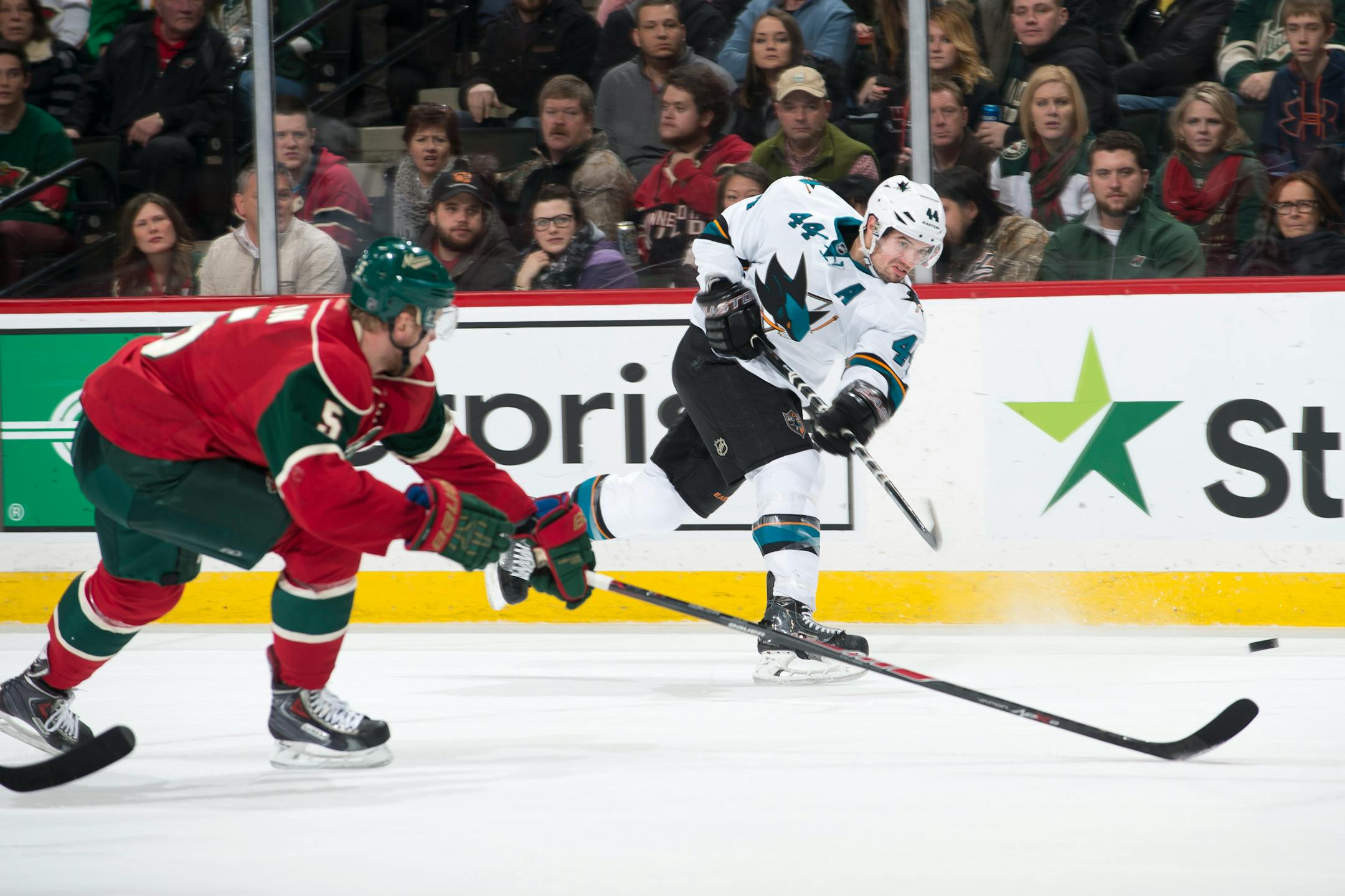 San Jose Sharks defenseman Marc-Edouard Vlasic (44) gets off a shot while being defended by Minnesota Wild defenseman Christian Folin (5) in the final seconds of overtime on Tuesday at Xcel Energy Center.