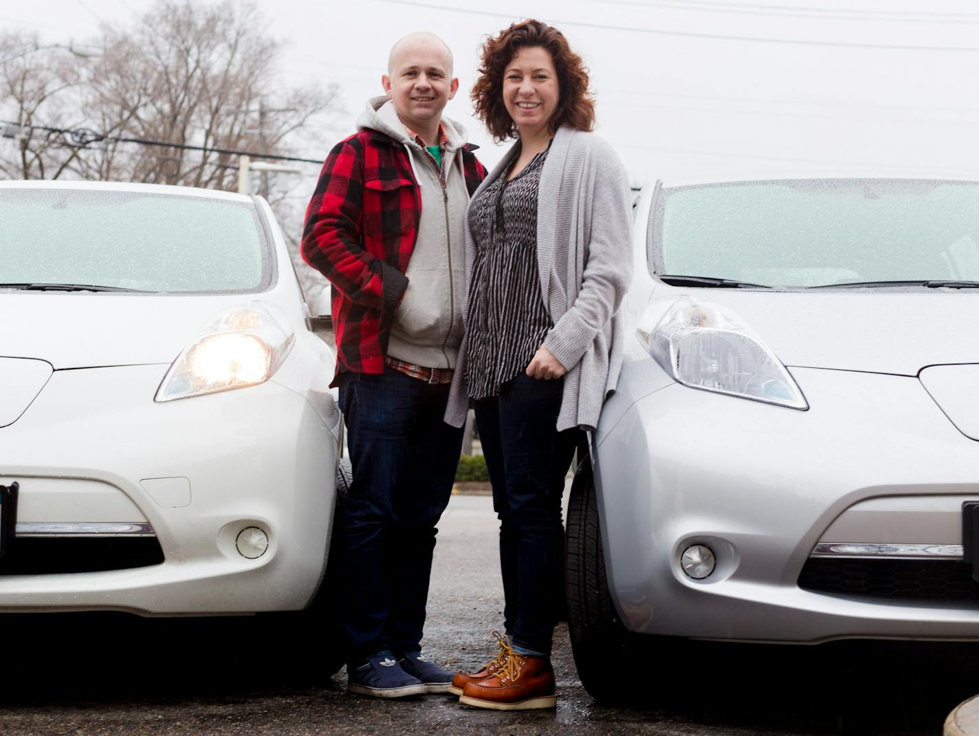 Matthew Blackler and Rhea O'Connor pose near their Nissan Leaf's, electric cars, at a BP off of Lyndale Ave. S, is the only service station in the state that has a Fast Charger, which can charge to 80 percent in 20 minutes. ] Elizabeth Brumley special to the Star Tribune * Minnesota legislators are debating possible tax rebates for those who buy new electric or hybrid vehicles. The proposal is being led by Rep. Pat Garofalo, who owns a high-performance, all-electric Tesla. The program would give