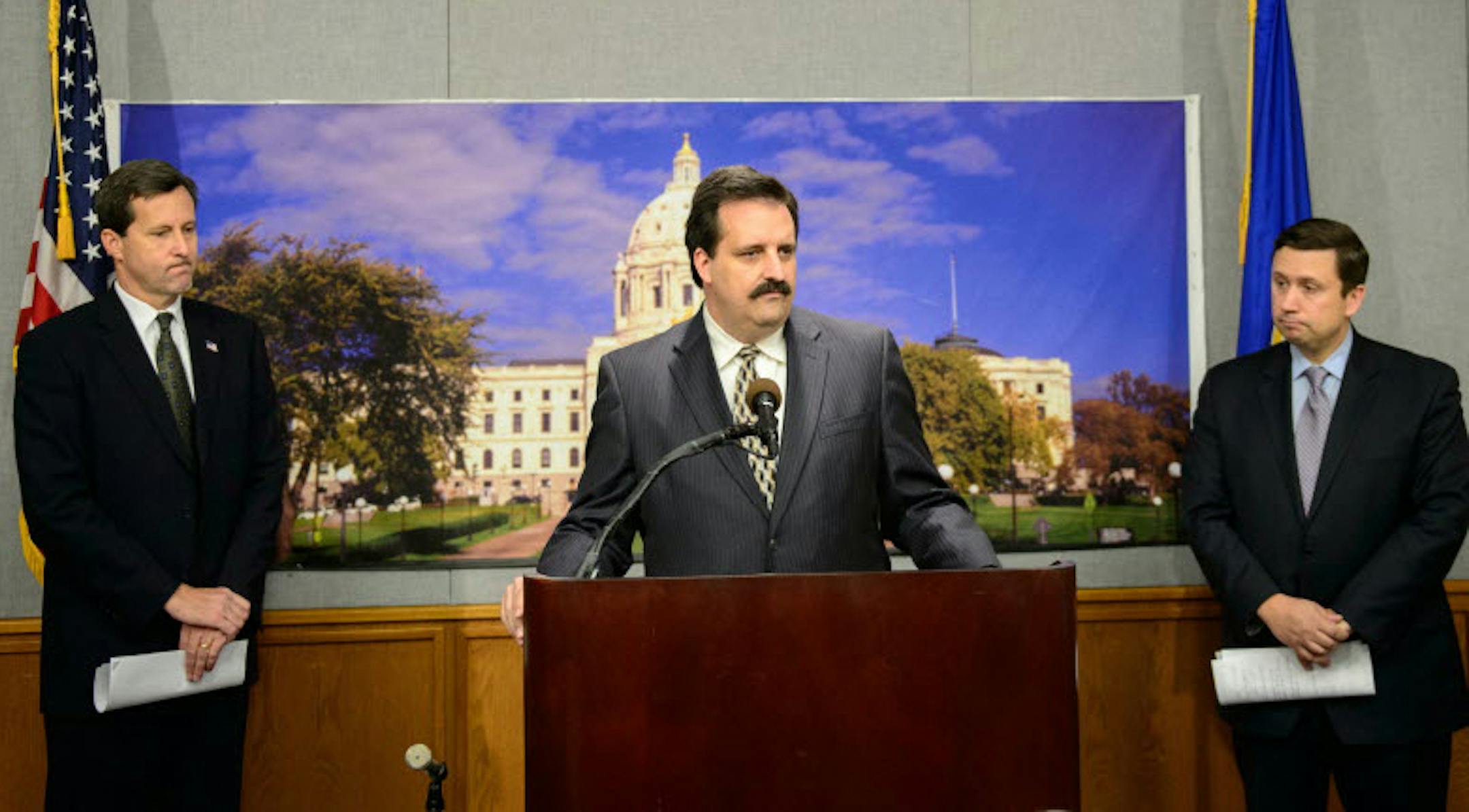 IP chairman Mark Jenkins, center, with the GOP's Keith Downey, left, and the DFL's Ken Martin, right.