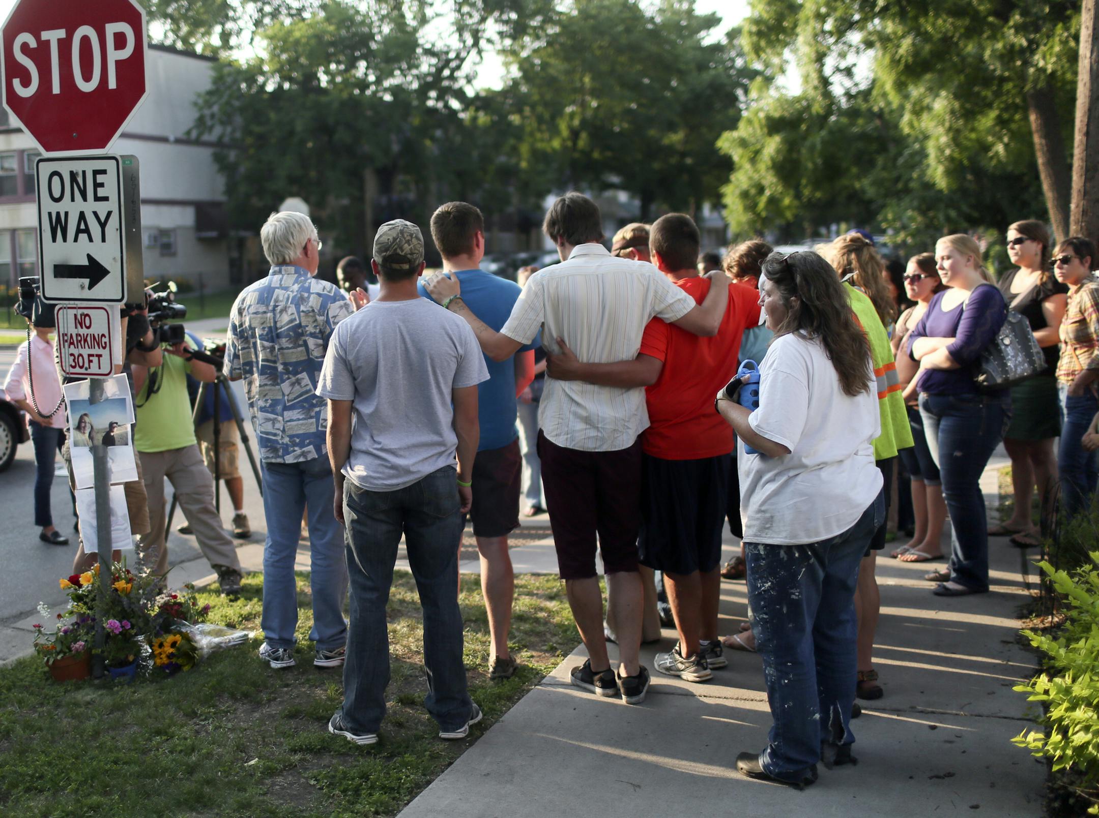 Justin Beckman, center, in white shirt, joined Jessica Hanson's family and friendsat the corner of Pleasant and 28th St. in south Minneapolis for a vigil Friday, July 5, 2013, in Minneapolis, MN. ](DAVID JOLES/STARTRIBUNE) djoles@startribune.com Bicyclist Jessica Hanson was struck while by a hit and ride motorist while riding her bike Wednesday night near Pleasant Ave. and 28th St in south Minneapolis and died today.**Justin Beckman, Jessica Hanson,cq