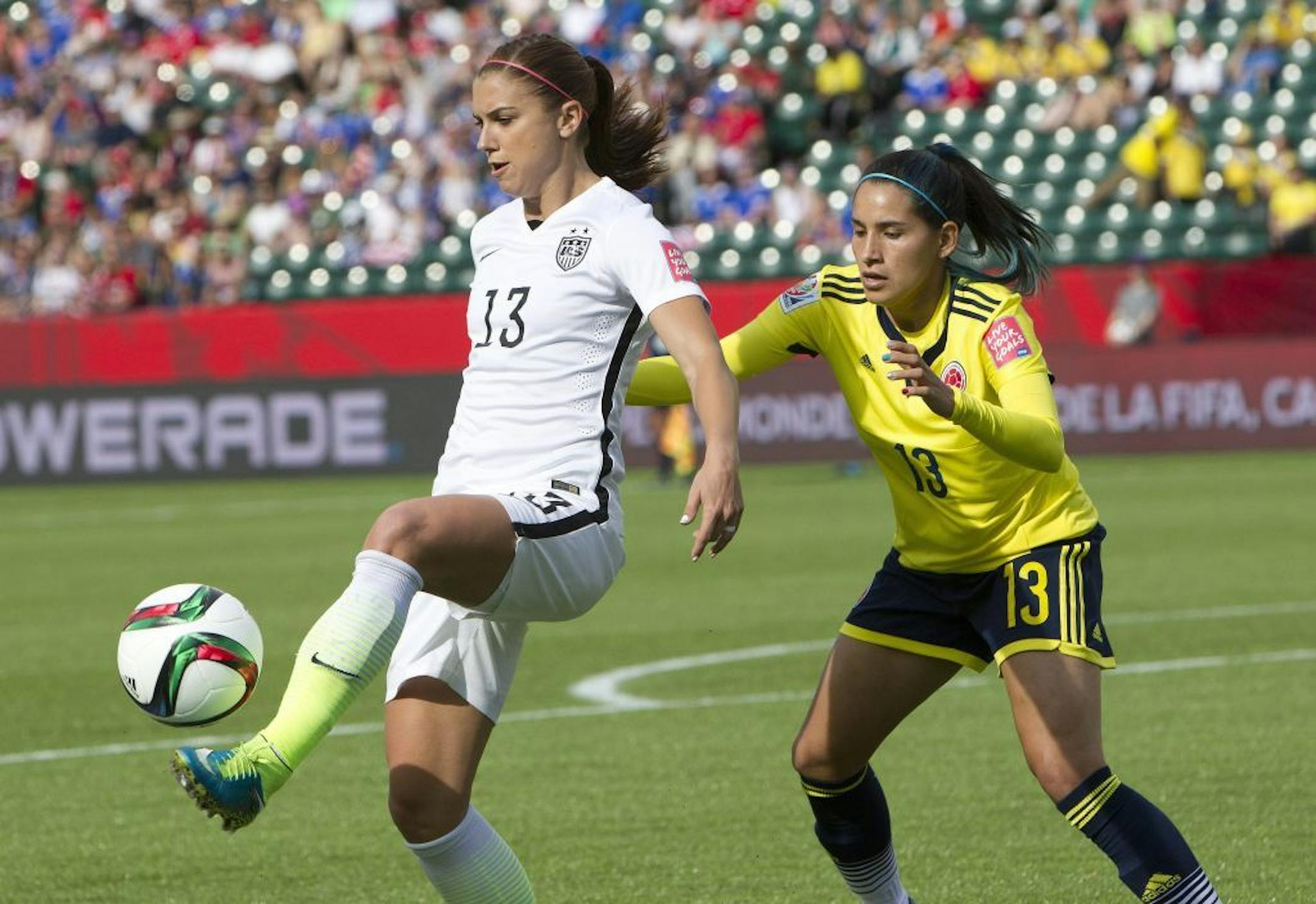 United States' Alex Morgan, left, kicked the ball in front of Colombia's Angela Clavijo during the first half of Monday's Women's World Cup round of 16 match in Edmonton, Alberta. The United States won 2-0.
