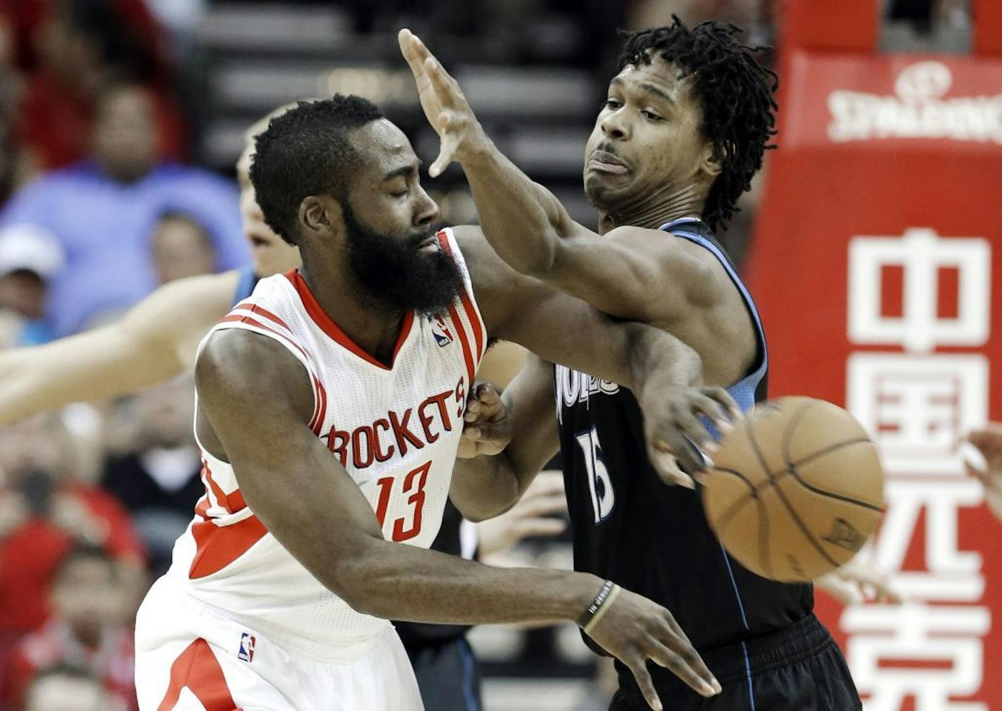 James Harden tries to pass the ball around the Timberwolves' Mickael Gelabale