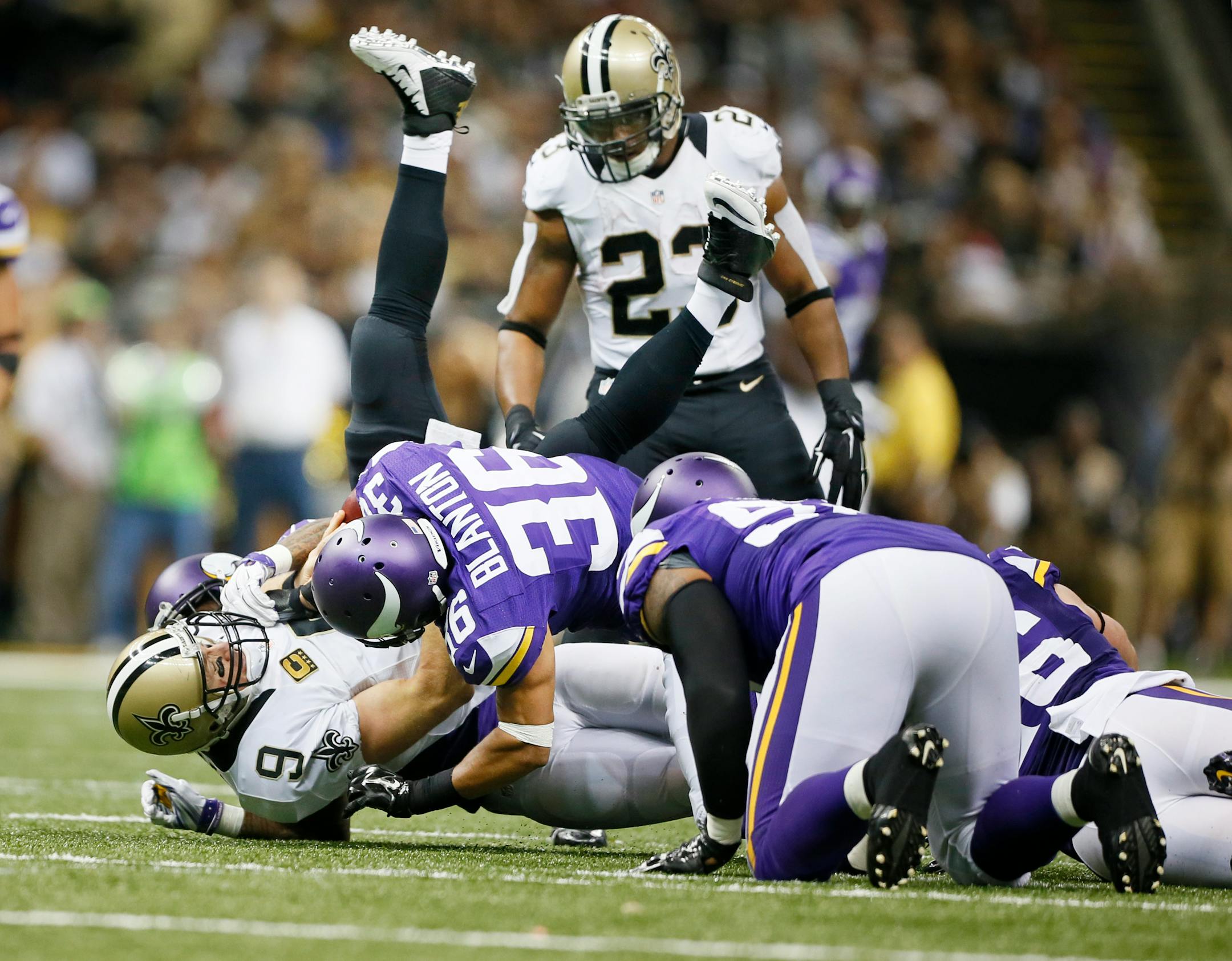 New Orleans Saints quarterback Drew Brees (9) was dumped by Minnesota Vikings cornerback Captain Munnerlyn (24) and strong safety Robert Blanton (36) in the third quarter . Munnerlyn was flagged for unnessary roughness on the play. The Minnesota Vikings played the New Orleans Saints at the Mercedes-Benz Superdome Sunday September 21 , 2014 in New Orleans ,LA. ] Jerry Holt Jerry.holt@startribune.com