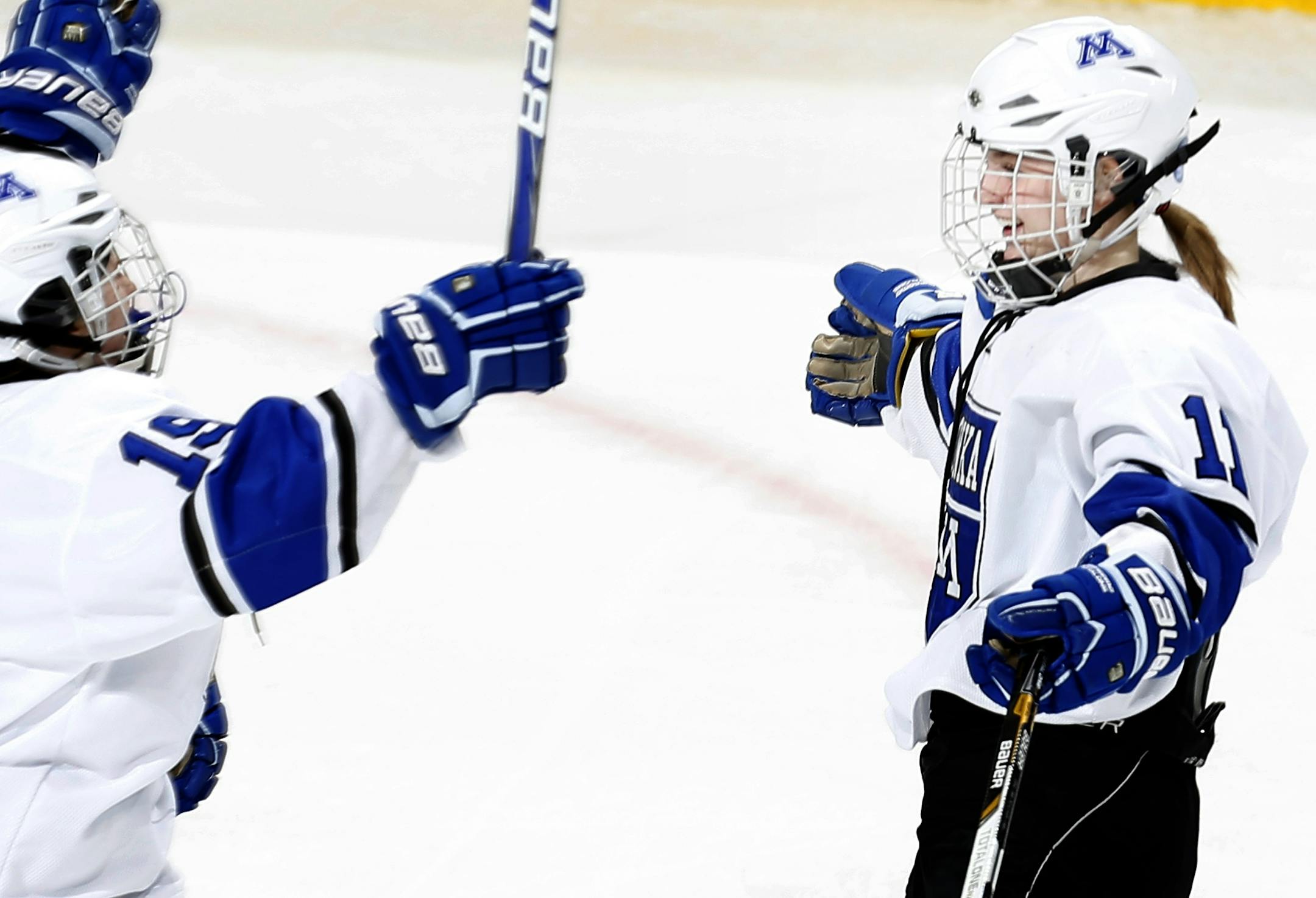 Kelsey Crow (19) and Hannah Behounek (11) celebrated a goal by Behounek in the first period. Minnetonka beat Irondale by a final score of 4-0.