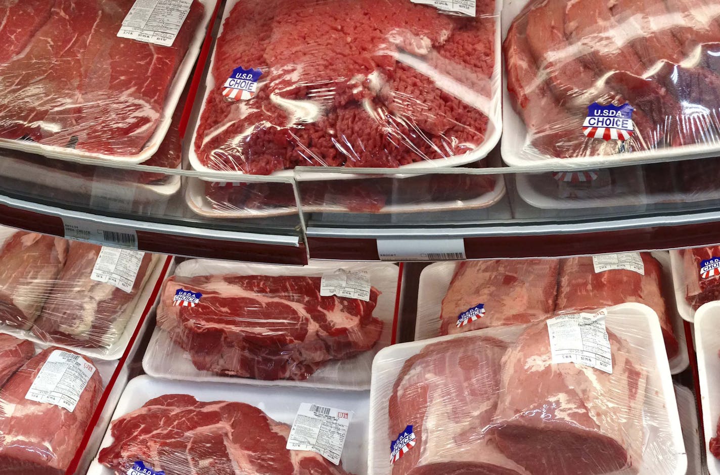 FILE - In this Nov. 2, 2013 file photo, various cuts of beef and pork are displayed for sale in the meat department at a discount market in Arlington, Va. Every five years, the government tells Americans how to eat healthier. Whether individuals listen or not, the dietary guidelines affect nutritional patterns throughout the country _ from federally-subsidized school lunches to labels on food packages to your doctor's advice. A government advisory committee is set to issue preliminary recommenda