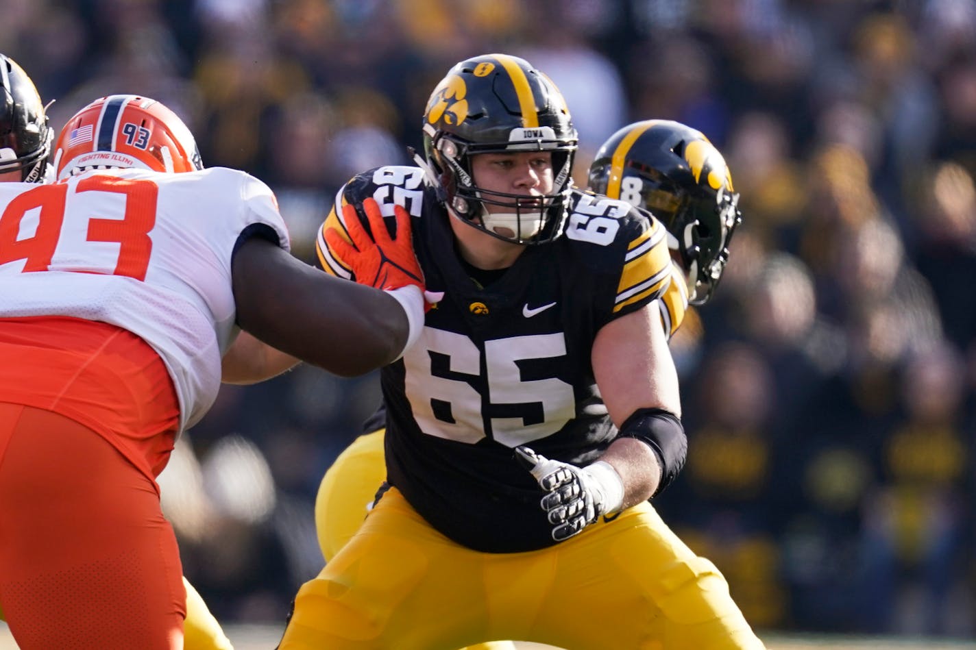 FILE - Iowa offensive lineman Tyler Linderbaum (65) looks to make a block during the first half of an NCAA college football game against Illinois, Nov. 20, 2021, in Iowa City, Iowa. Iowa center Tyler Linderbaum announced Friday, Jan. 14, 2022, he'll skip his senior season and enter the NFL draft. (AP Photo/Charlie Neibergall, File)