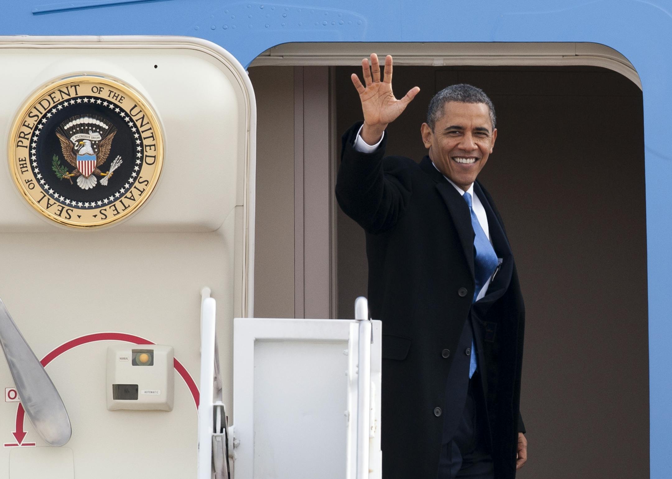 President Barack Obama waves as he boards Air Force One at Andrews Air Force Base, Md., Monday, Feb. 4, 2013, prior to traveling to Minnesota to talk about gun control.