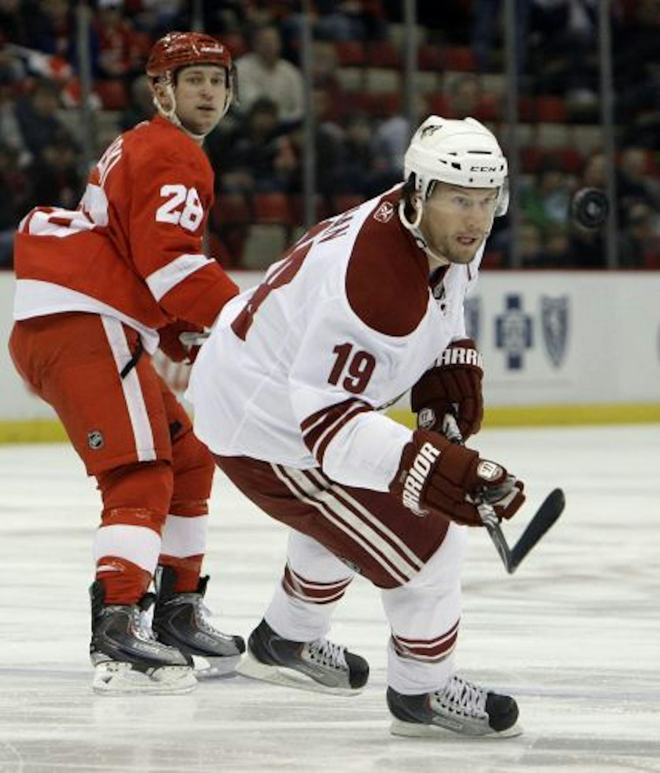 Phoenix Coyotes' Shane Doan (19) keeps his eye on the puck as Detroit Red Wings defenseman Brian Rafalski (28) defends during the first period of an NHL hockey game in Detroit, on Tuesday, Jan. 26, 2010.