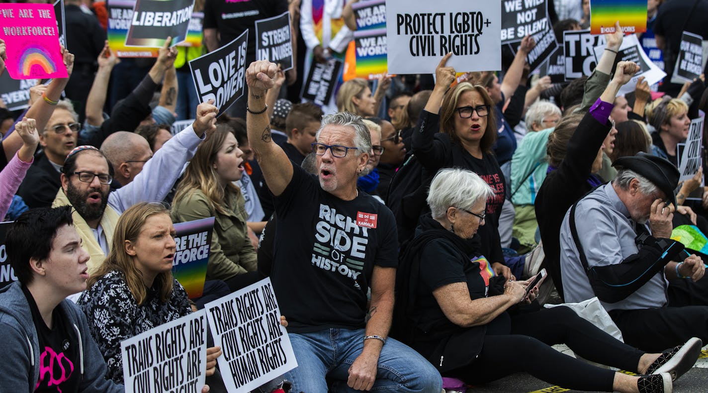 Supporters of LGBT rights sit in the street in front of the U.S. Supreme Court as they stage a sit in protest Tuesday, Oct. 8, 2019, in Washington. The Supreme Court heard arguments in its first cases on LGBT rights since the retirement of Justice Anthony Kennedy. (AP Photo/Manuel Balce Ceneta)