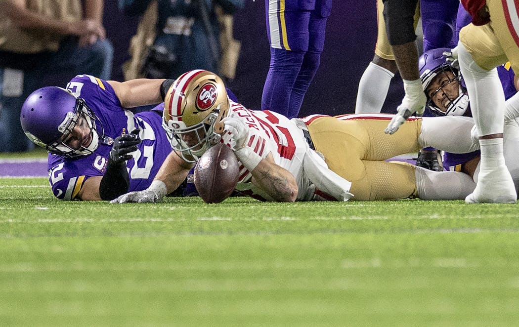 Vikings safety Harrison Smith, left, was credited with forcing Christian McCaffrey’s fumble in the first quarter against the 49ers on Monday night. Smith and Camryn Bynum agree to disagree on that.