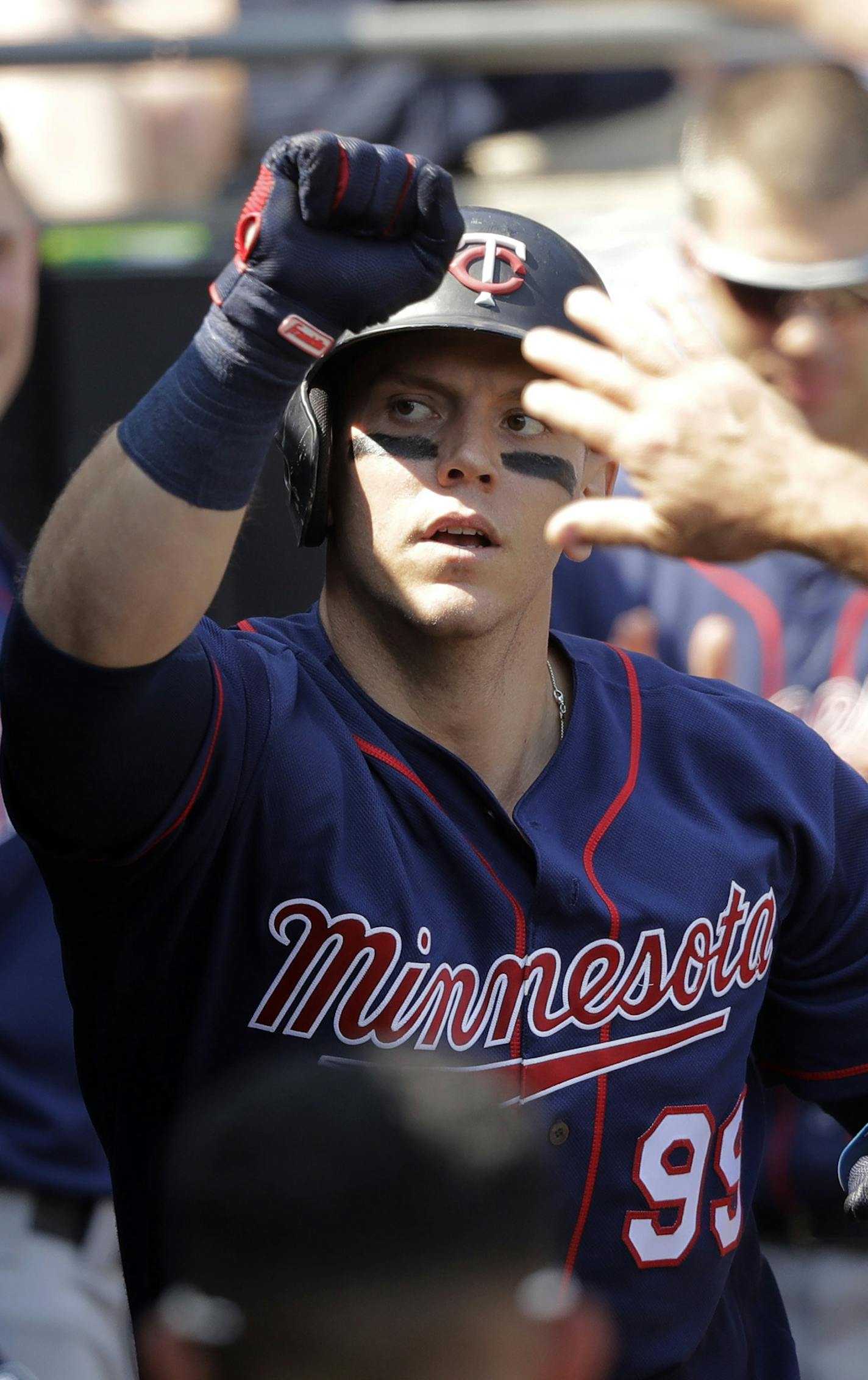 Minnesota Twins' Logan Morrison celebrates his home run off Chicago White Sox starting pitcher Lucas Giolito, in the dugout during the seventh inning of a baseball game Thursday, June 28, 2018, in Chicago. (AP Photo/Charles Rex Arbogast)