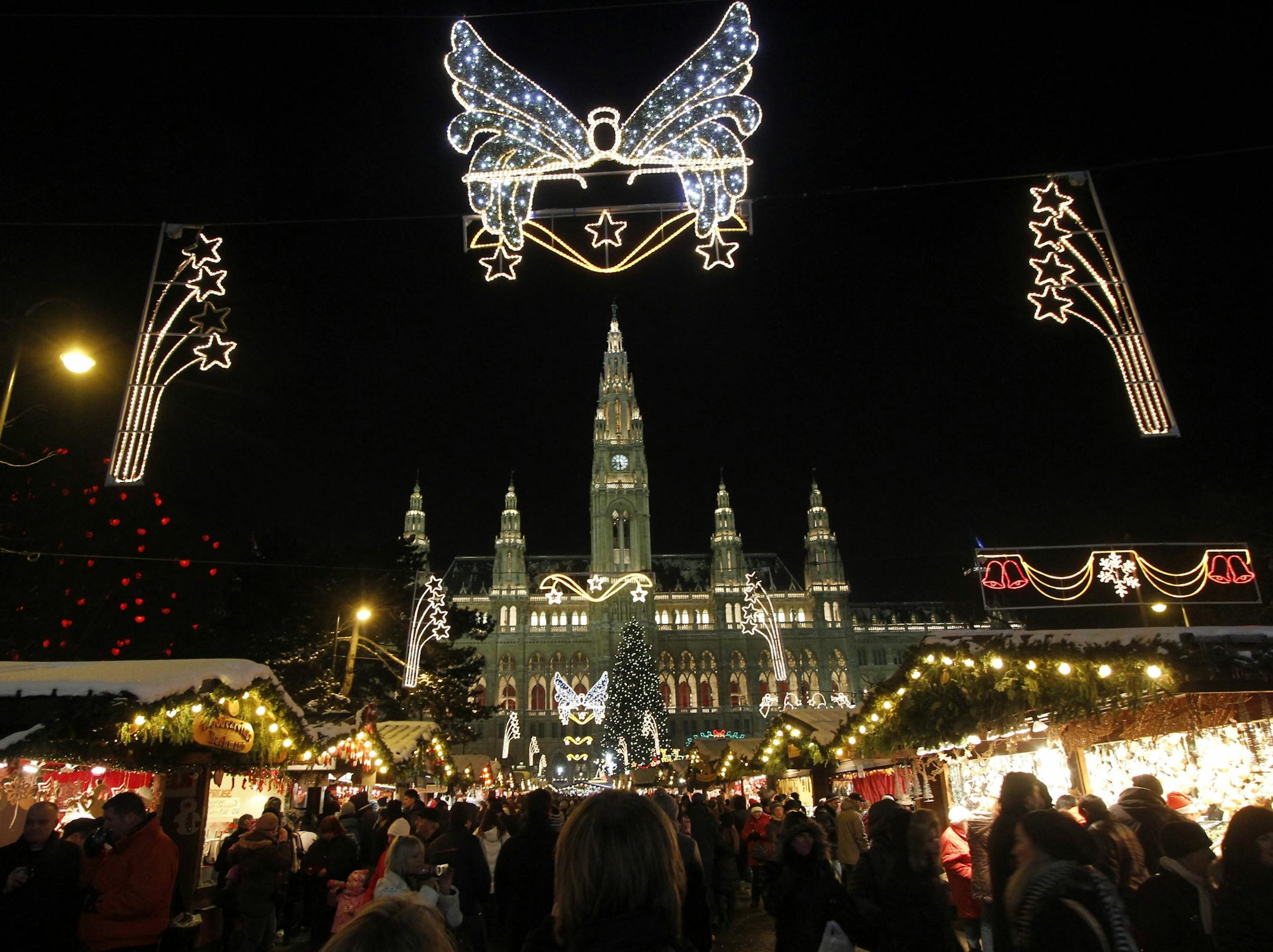Amid a backdrop of thousands of holiday lights, scores of shoppers explored Vienna's largest and best-known traditional Christmas market near the City Hall.