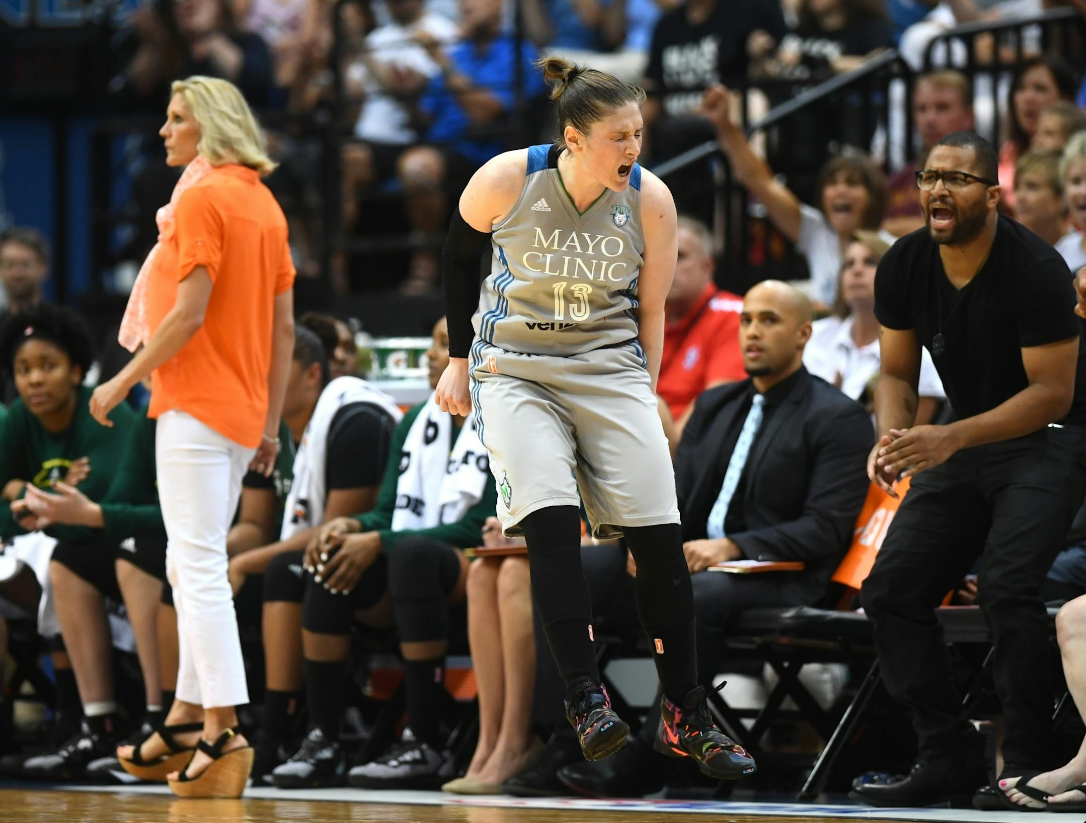 Minnesota Lynx guard Lindsay Whalen (13) celebrated a 3-pointer in front of the Seattle Storm bench late in the second quarter Friday night.