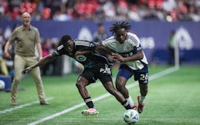 Minnesota United's Bongokuhle Hlongwane, left, and Vancouver's J.C. Ngando vie for the ball during the first half Wednesday in Vancouver.
