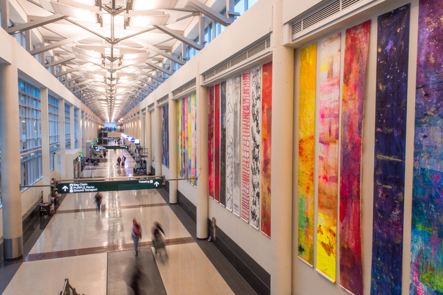 Scrolls from "122 Conversations," by Anne Labovitz, greet passengers at the entrance to Terminal 2.