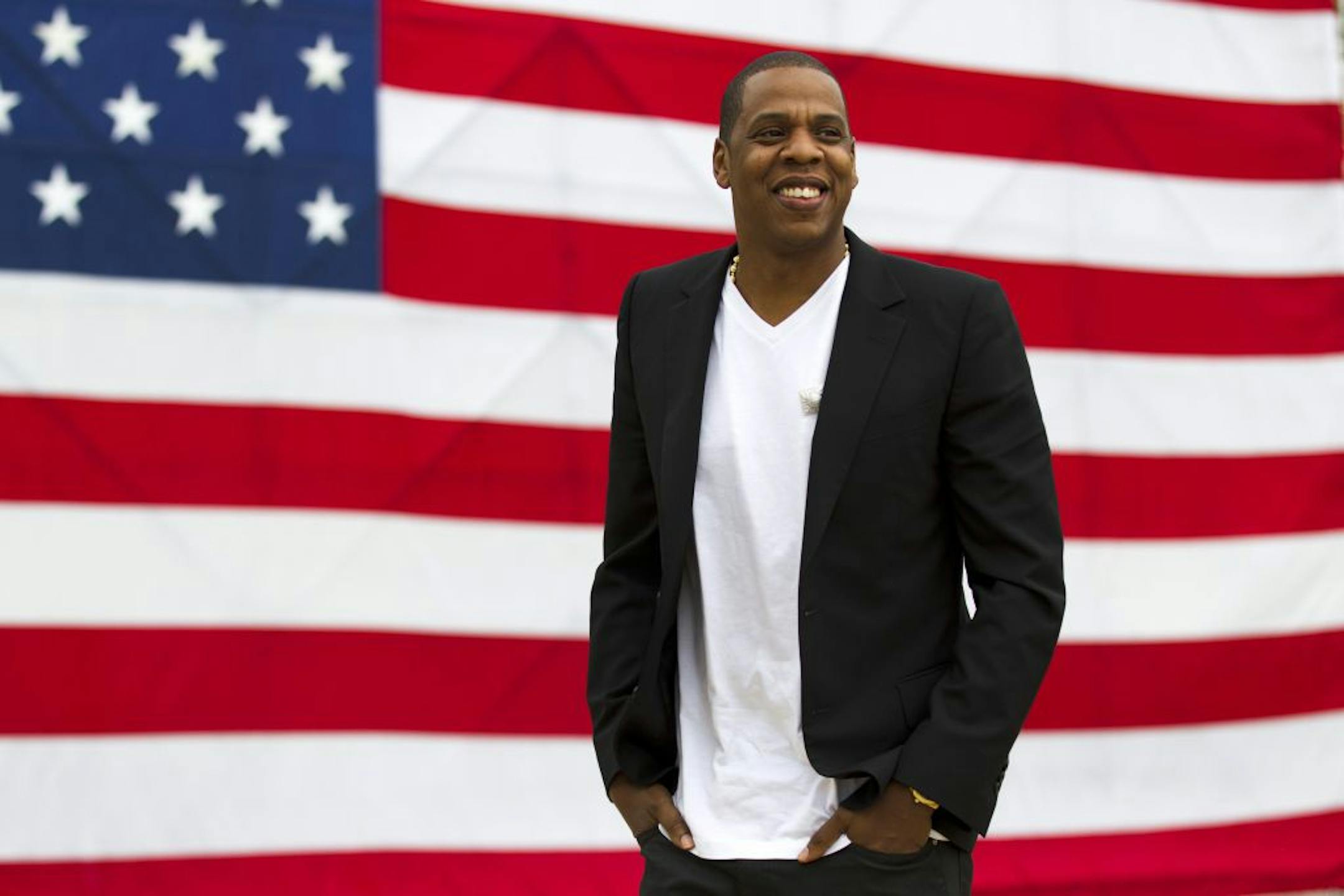FILE - In this May 14, 2012 file photo, entertainer Shawn "Jay-Z" Carter smiles in between interviews, after a news conference at Philadelphia Museum of Art in Philadelphia. The city where America was made is gearing up for rapper Jay-Z's "Made In America" music festival, which officials estimate will attract 100,000 fans to Philadelphia over Labor Day weekend, Sept. 1-2, 2012. The festival is sponsored by Budweiser.
