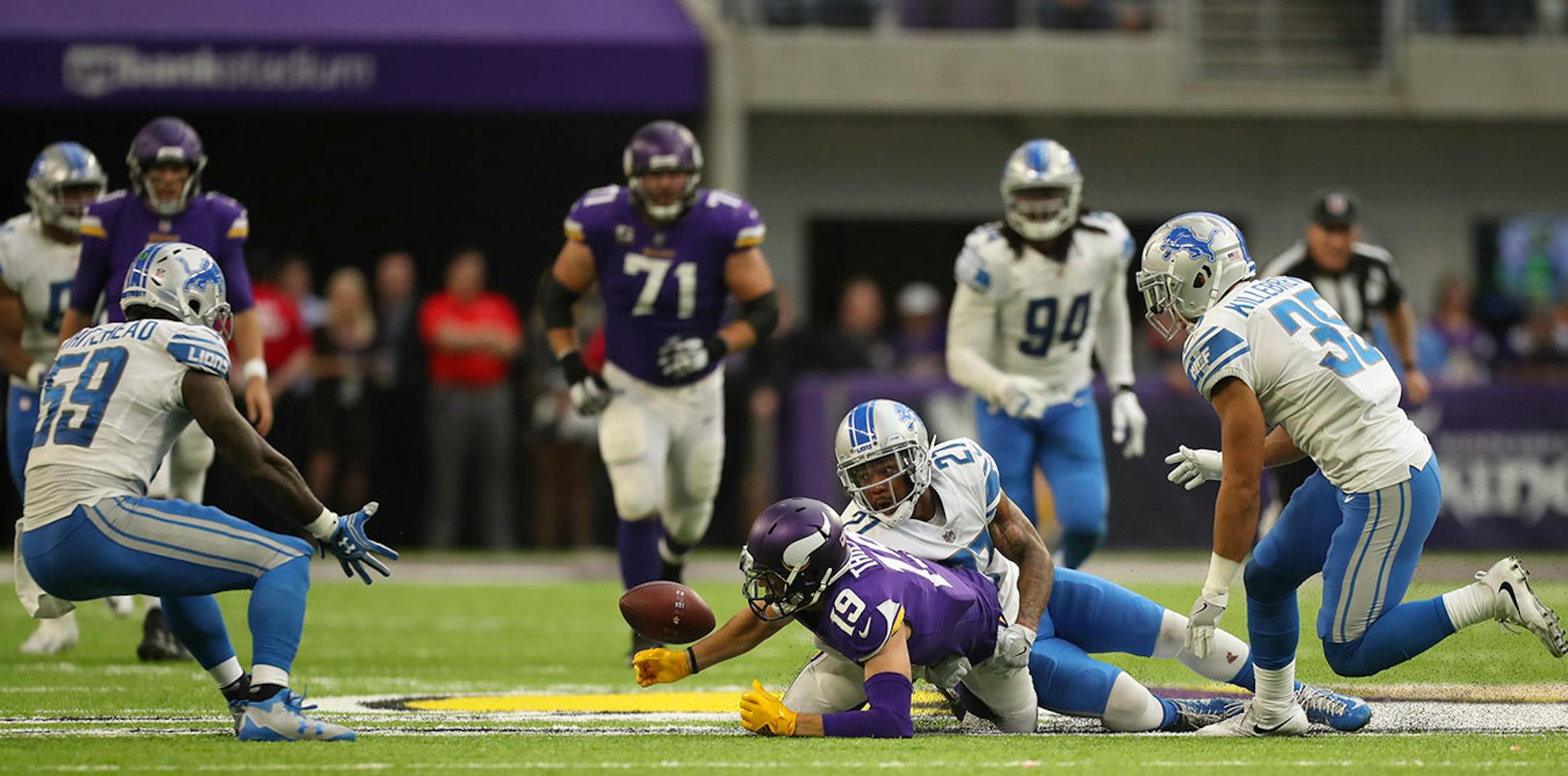 Minnesota Vikings wide receiver Adam Thielen (19) fumbled after making an 11 yard pass reception with under two minutes left in the fourth quarter, sealing the Vikings' loss when Detroit Lions middle linebacker Tahir Whitehead, left, recovered it.