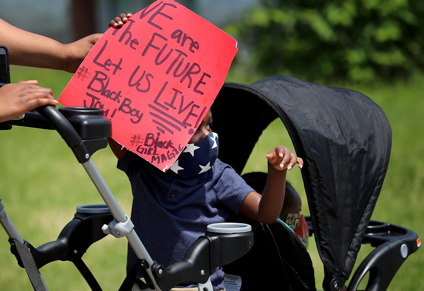 A young member of the Williams family (only wanted family named used) held a sign as clergy of color lead other clergy members during a Silent Clergy March from Sabathani Community Center down 38th St. to Cup Foods and the George Floyd Memorial for prayers and then a march back to Sabathani.Tuesday, June 2, 2020, in Minneapolis, MN.] DAVID JOLES • david.joles@startribune.com Latest on the death of George Floyd.