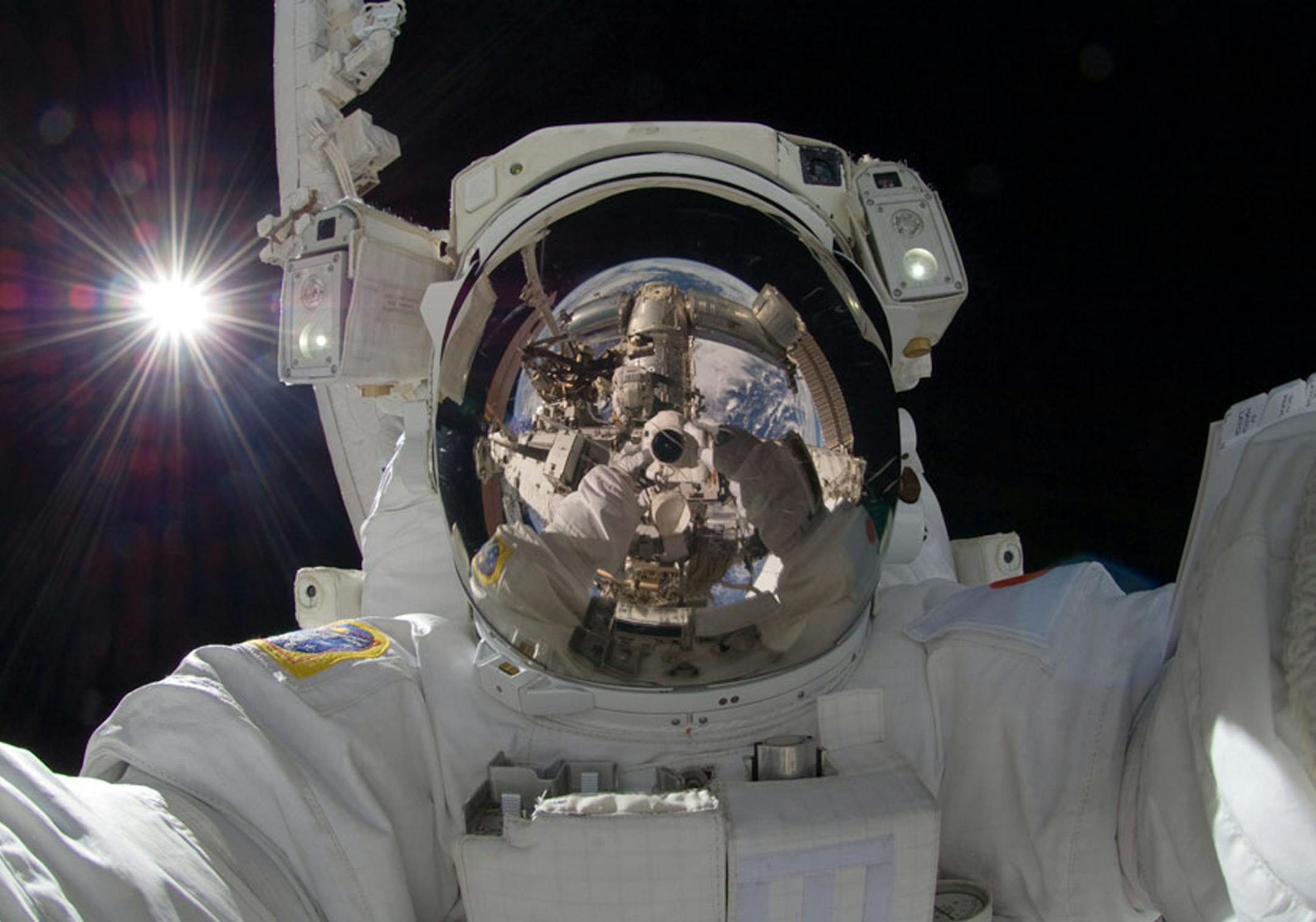 This Sept. 18, 2012 photo released by NASA shows international space station astronaut Aki Hoshide taking a self-portrait while in space. The practice of freezing and sharing our tiniest slices of life in "selfies" has become so popular that the granddaddy of dictionaries, the Oxford, is monitoring the term as a possible addition. (AP Photo/NASA) ORG XMIT: MIN2013071620462516