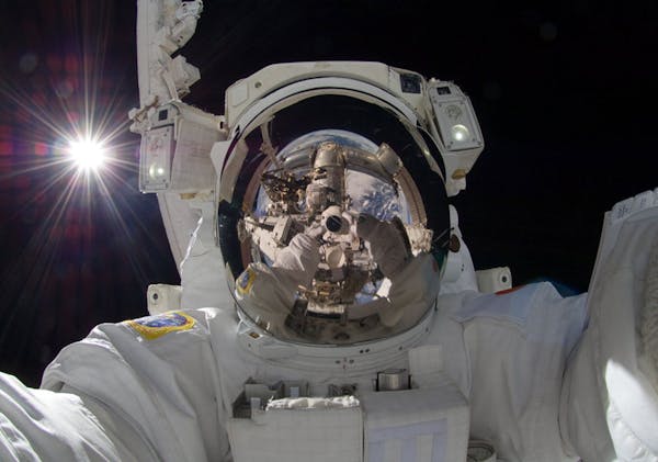 This Sept. 18, 2012 photo released by NASA shows international space station astronaut Aki Hoshide taking a self-portrait while in space. The practice