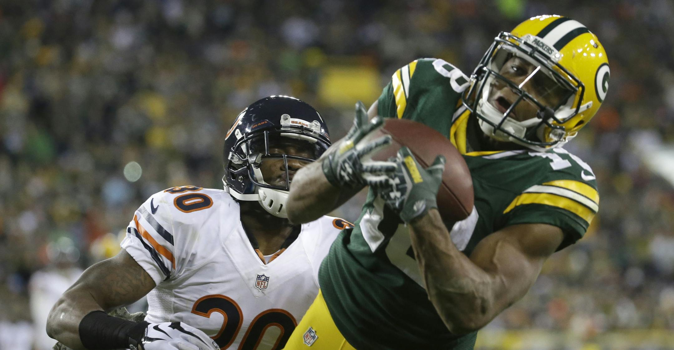 Green Bay Packers wide receiver Randall Cobb (18) makes a touchdown catch against Chicago Bears cornerback Demontre Hurst (30) during the first half of an NFL football game Sunday, Nov. 9, 2014, in Green Bay, Wis. (AP Photo/Morry Gash)