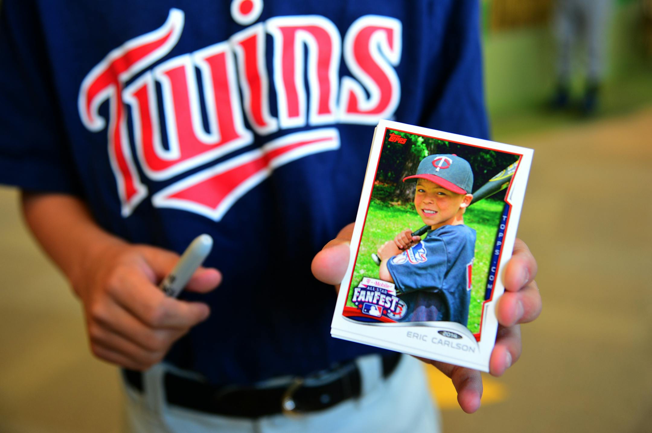 Eric Carlson, 10, of Chanhassen showed off his own baseball card.