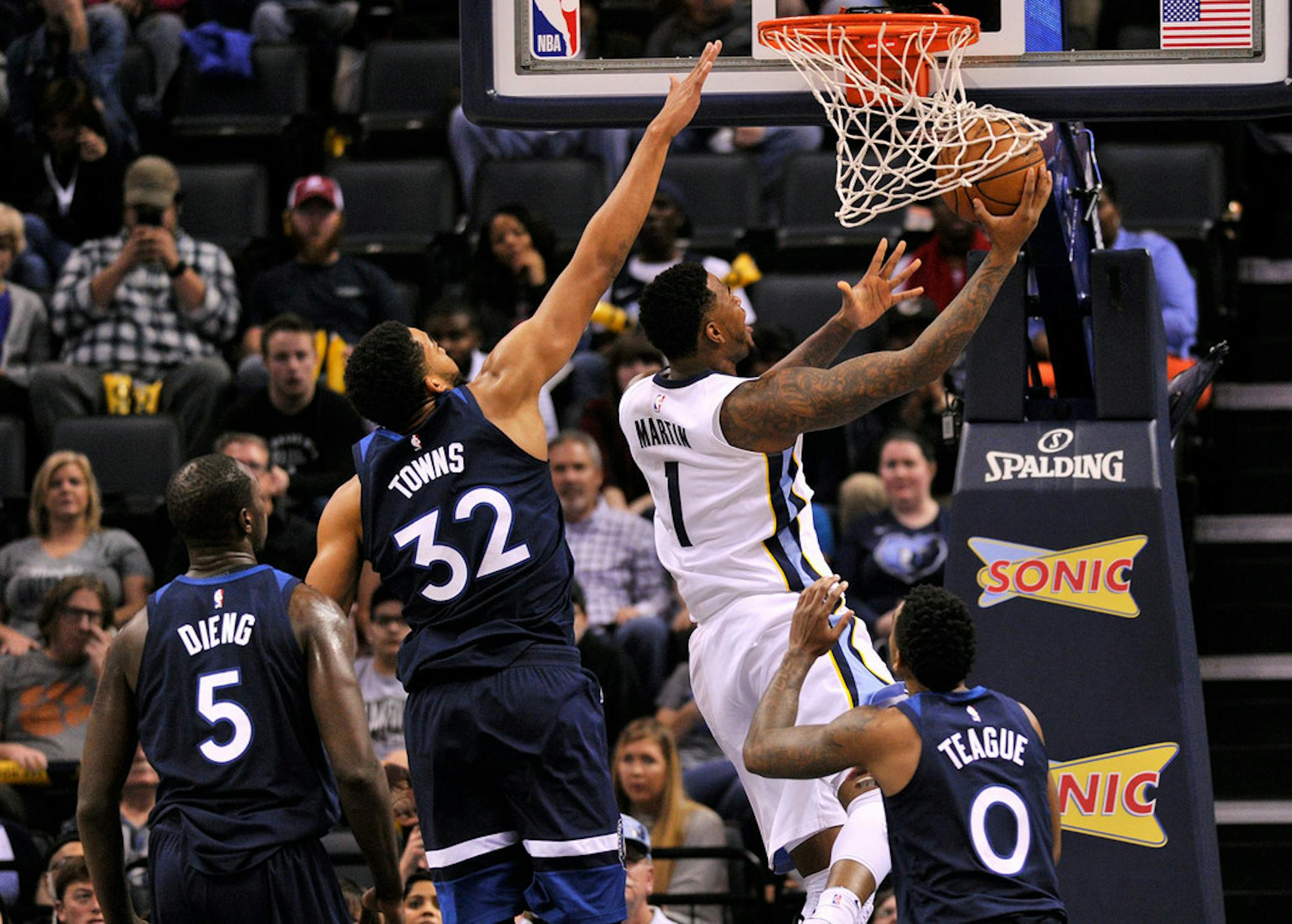 Grizzlies forward Jarell Martin shot a reverse layup against Timberwolves center Karl-Anthony Towns (32), guard Jeff Teague (0) and center Gorgui Dieng (5) in the first half Monday.