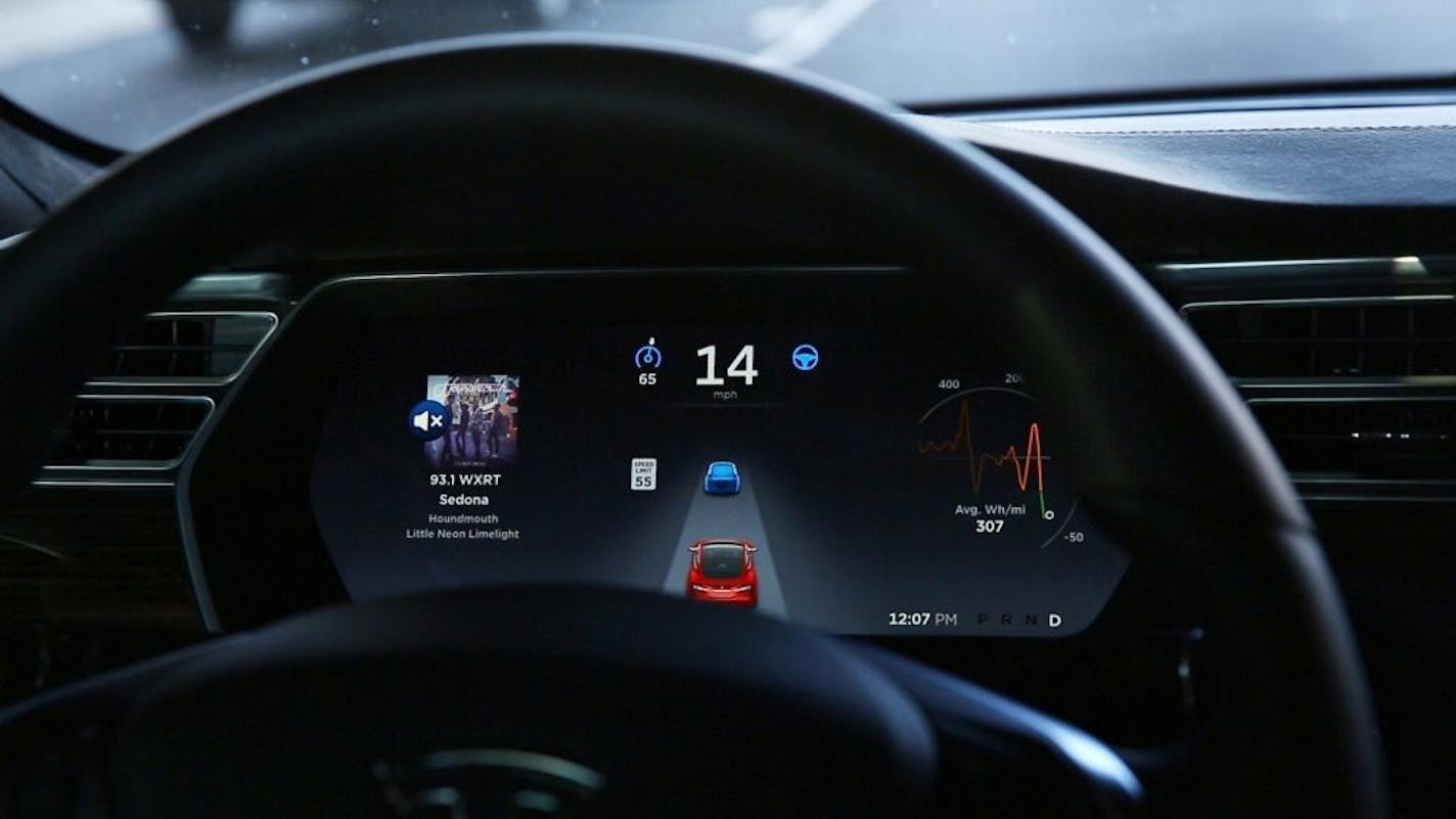 The dashboard of the software-updated Tesla Model S P90D shows the icons enabling Tesla's autopilot, featuring limited hands-free steering, making the Tesla the closest thing on the market to an autonomous-driving enabled vehicle.