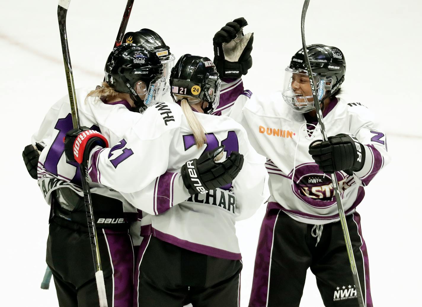 Audra Richards (21, shown being congratulated after scoring a goal in the NWHL All-Star Game last February) has signed with the Minnesota Whitecaps.