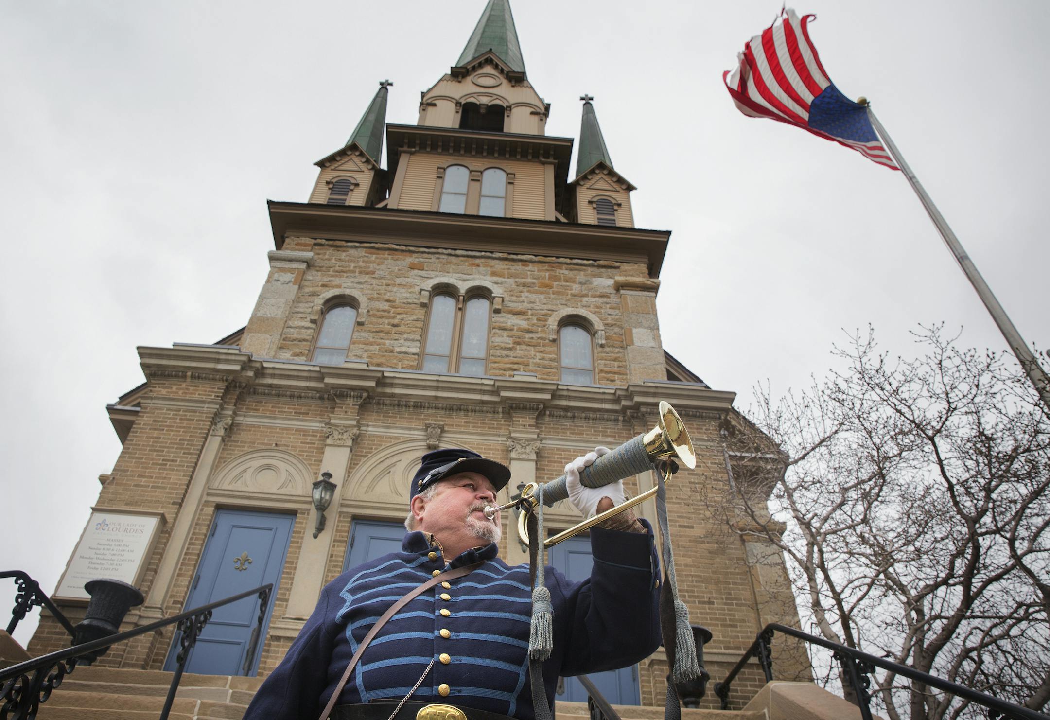 Bugle player William Crowder plays Taps outside Our Lady of Lourdes Catholic Church following a nationwide bell ringing to commemorate the 150th anniversary of events at a Virginia court house which symbolically ended the Civil War. Unfortuntely, they experienced techinical difficulties and the bells didn't ring at Our Lady of Lourdes Catholic Church during the event. ] LEILA NAVIDI leila.navidi@startribune.com /