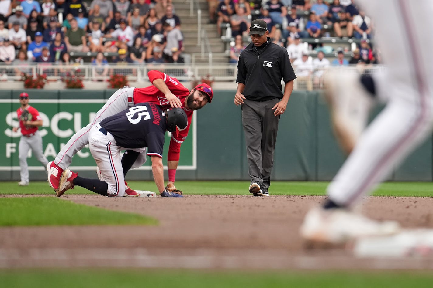 Los Angeles Angels second baseman Michael Stefanic (38) is tripped by Minnesota Twins center fielder Andrew Stevenson (45) as throws to first for the double play to end the fifth inning of an MLB game between the Minnesota Twins and the Los Angeles Angels Saturday, 23, 2023 at Target Field in Minneapolis. ] ANTHONY SOUFFLE • anthony.souffle@startribune.com