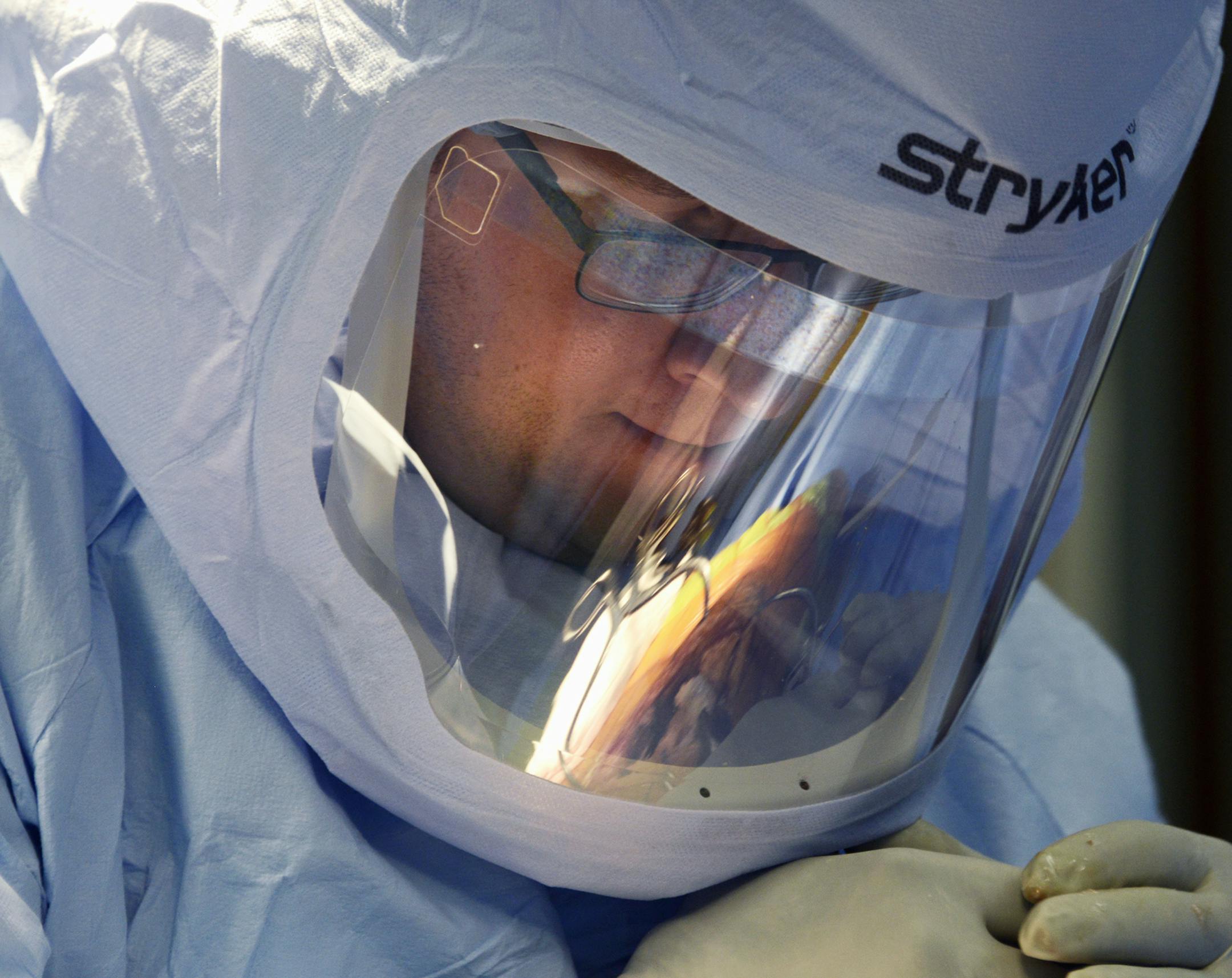 Dr. Timothy Sauber, an orthopedic surgeon at West Penn Hospital of the Allegheny Health Network, works to remove the localized arthritic part of a knee. (Darrell Sapp/Pittsburgh Post-Gazette/TNS)
