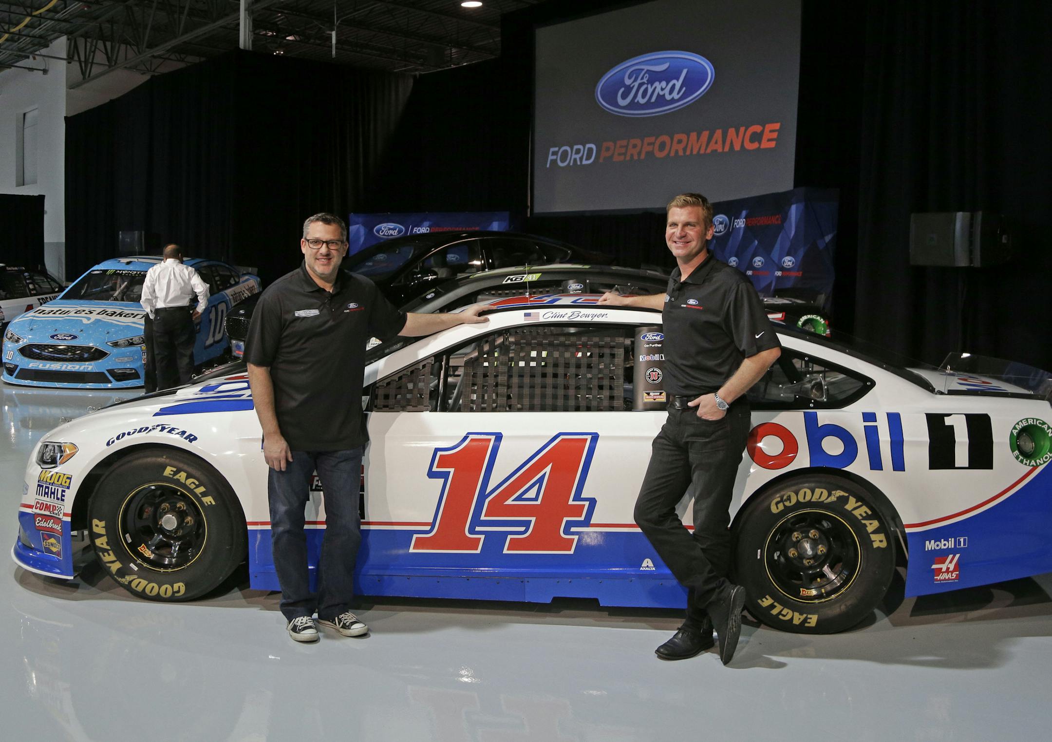 Team owner Tony Stewart, left, and driver Clint Bowyer pose for a photo during a news conference in Concord, N.C., Wednesday, Jan. 18, 2017. (AP Photo/Chuck Burton)