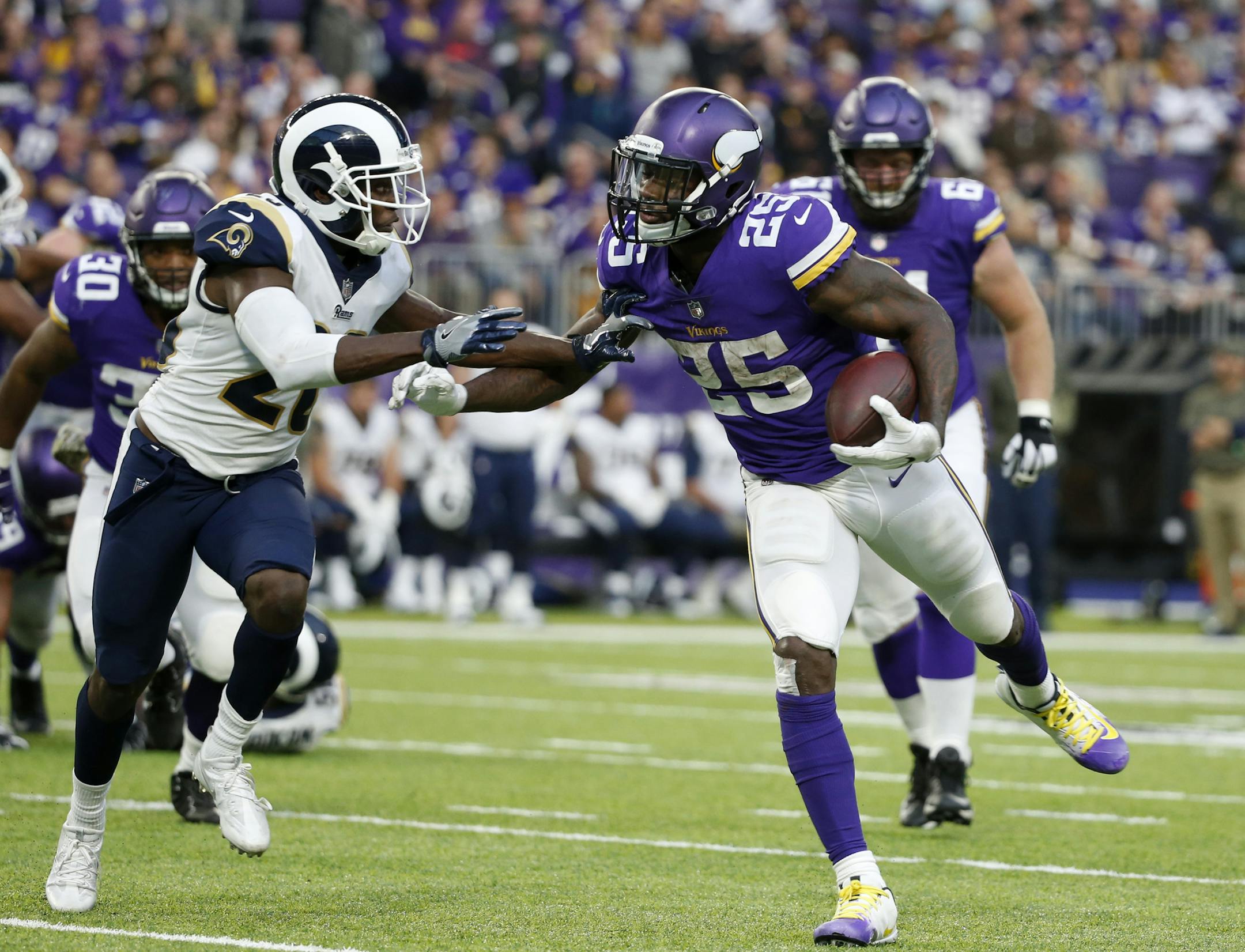 Minnesota Vikings running back Latavius Murray (25) runs from Los Angeles Rams free safety Lamarcus Joyner, left, during the second half of an NFL football game, Sunday, Nov. 19, 2017, in Minneapolis. The Vikings won 24-7. (AP Photo/Bruce Kluckhohn)