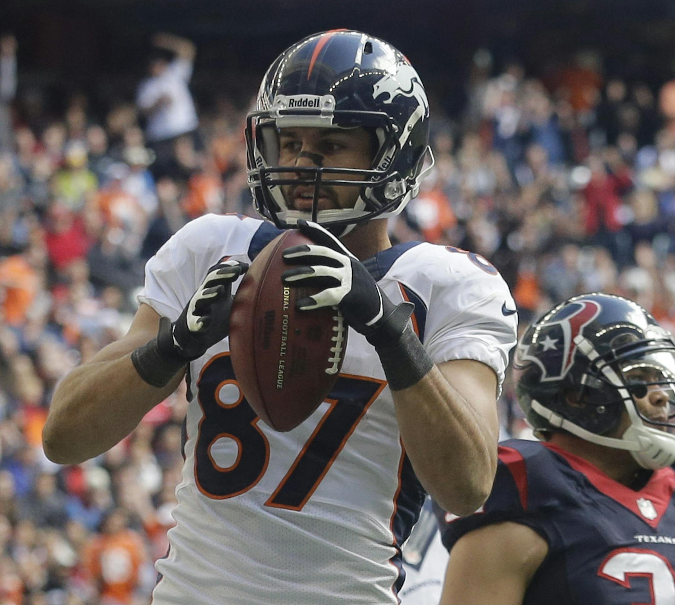 Denver Broncos' Eric Decker (87) scores a touchdown against the Houston Texans during the third quarter of an NFL football game, Sunday, Dec. 22, 2013, in Houston. (AP Photo/Patric Schneider)