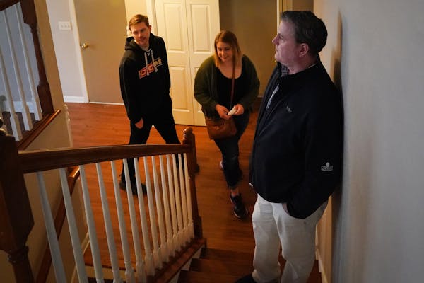 In this April photo, Elizabeth Mayer and Damon Madzey tour a townhome they bought that was listed by realtor Chris Willette, at right. ] Shari L. Gros