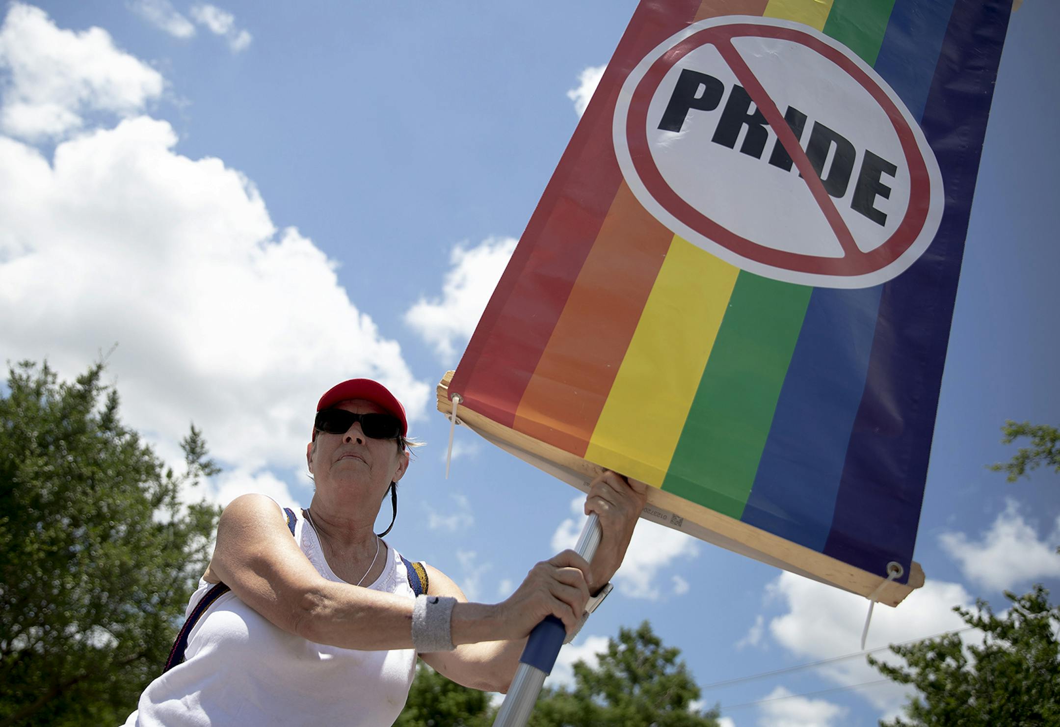 Paula Pompa holds up a sign during a protest outside of the Leander Public Library on Saturday, June 15, 2019, in Leander, Texas. Anti-LGBT protesters and LGBT supporters gathered outside of the library where a "Drag Queen Story Hour" was set to take place. (Nick Wagner/Austin American-Statesman via AP)