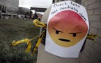A sign with an emoji reads "Don't take net neutrality away" is posted outside the Federal Communications Commission (FCC), in Washington, Thursday, De