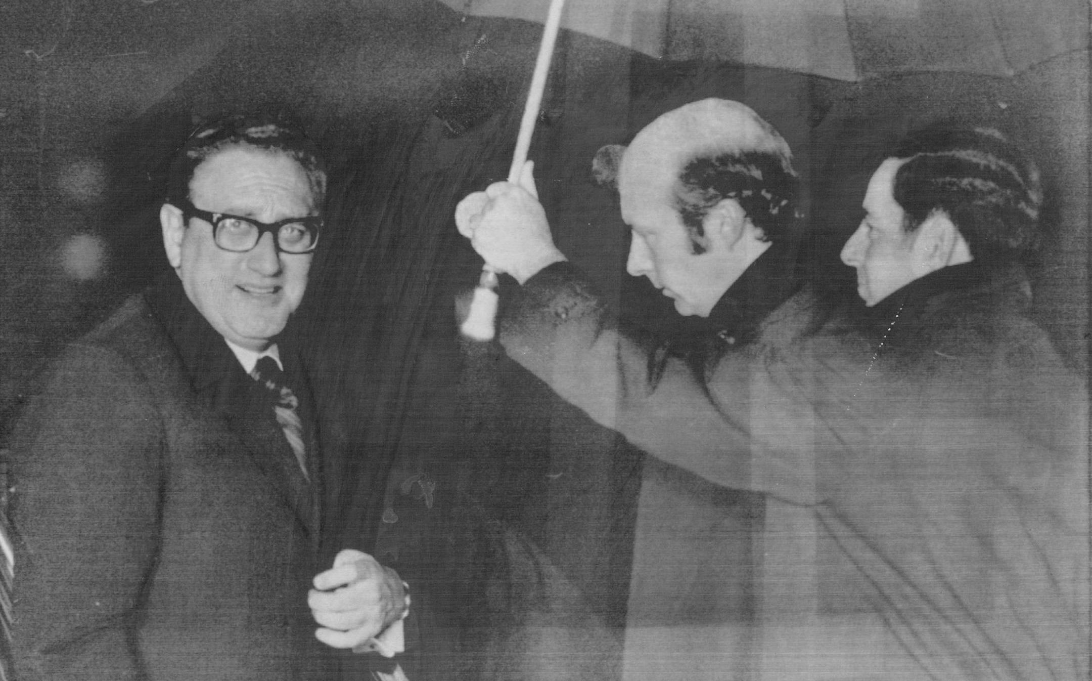 January11, 1974 Kissinger Ducked under an umbrella to keep dry - He left Andrews Air Force Base for Mideast early today U.S. Secretary of State Henry kissinger arrived in Madrid today on a brief stopover en route to his new peace mission to the Middle East. The trip marks Kissinger's third Mideast tour since the October war and comes at a time of increasing clashes along the truce lines and warnings of more fighting. Associated Press