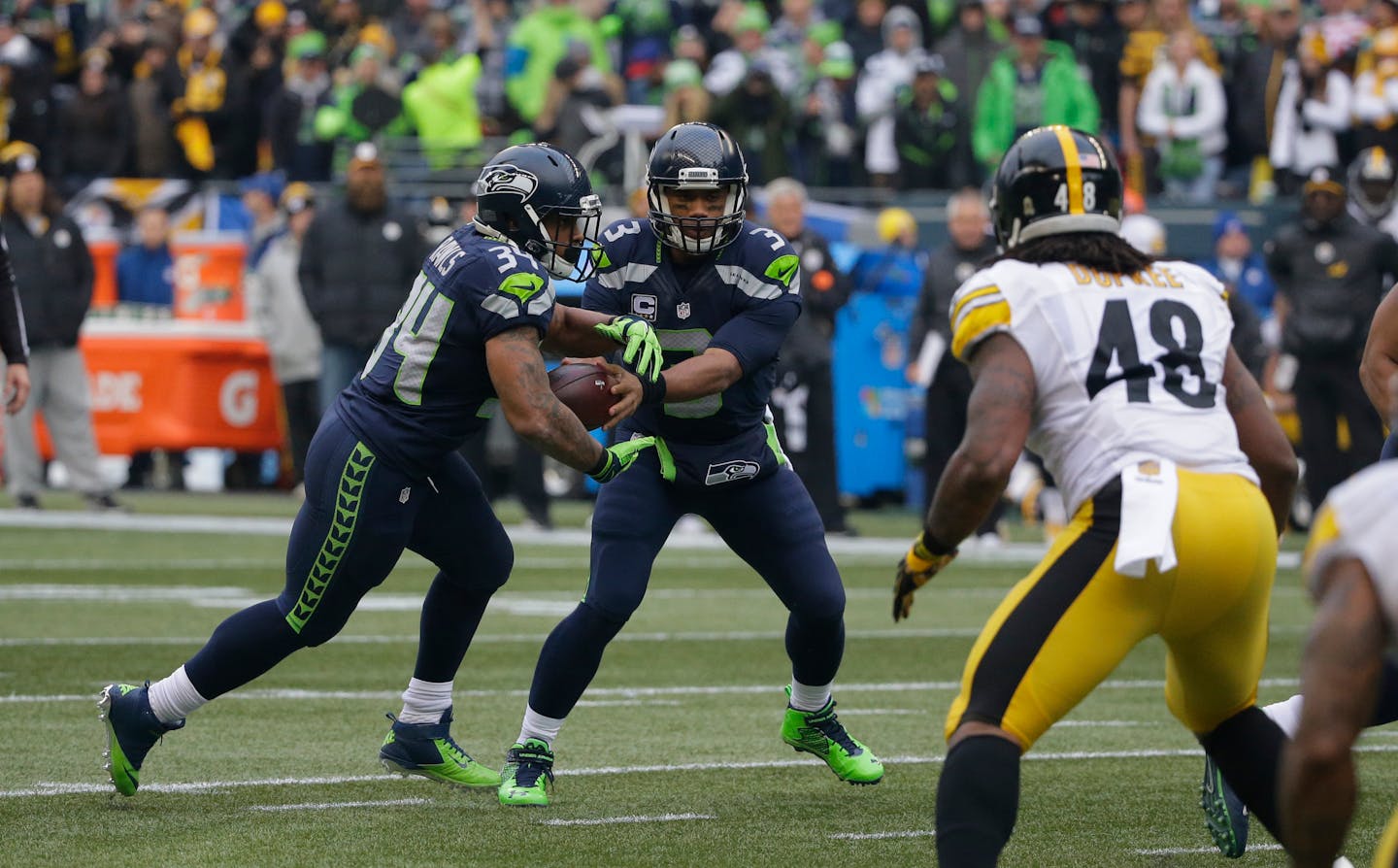 Hand it off or keep it? That&#x2019;s the choice Seahawks QB Russell Wilson makes in every read-option play, this one with rookie Thomas Rawls.