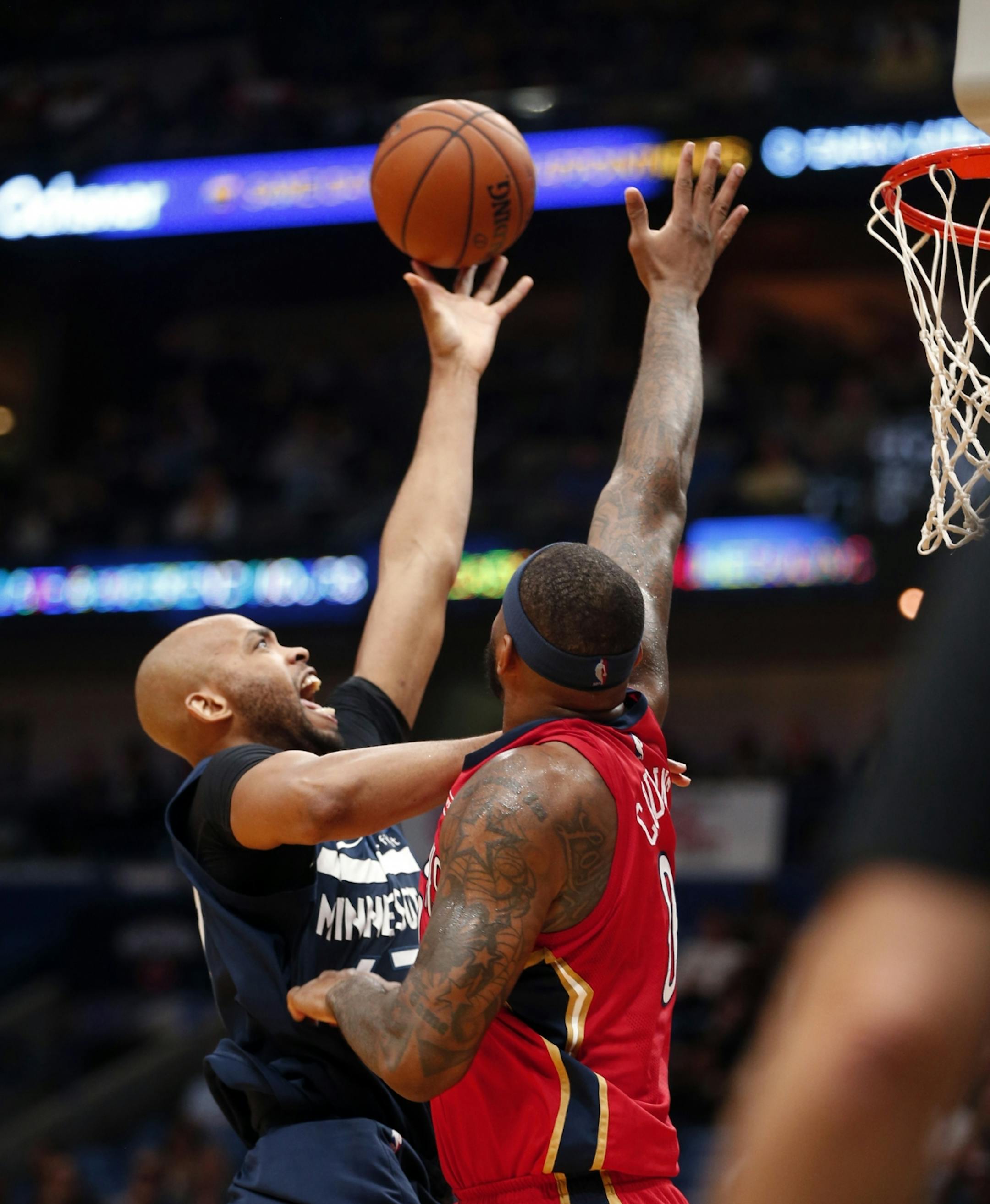 Minnesota Timberwolves forward Taj Gibson, left, drives to the basket against New Orleans Pelicans center DeMarcus Cousins during the first half of an NBA basketball game in New Orleans, Wednesday, Nov. 29, 2017.