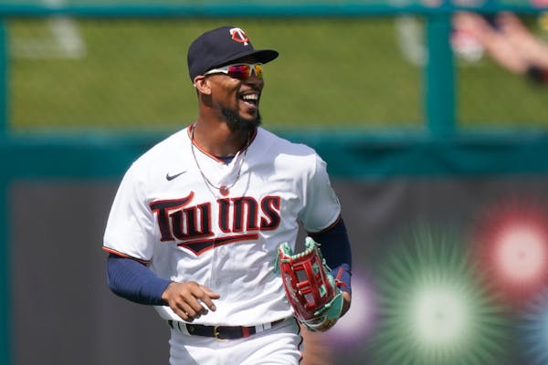 Minnesota Twins center fielder Byron Buxton runs off the field smiling after an outfield catch in the second inning during a spring training baseball 