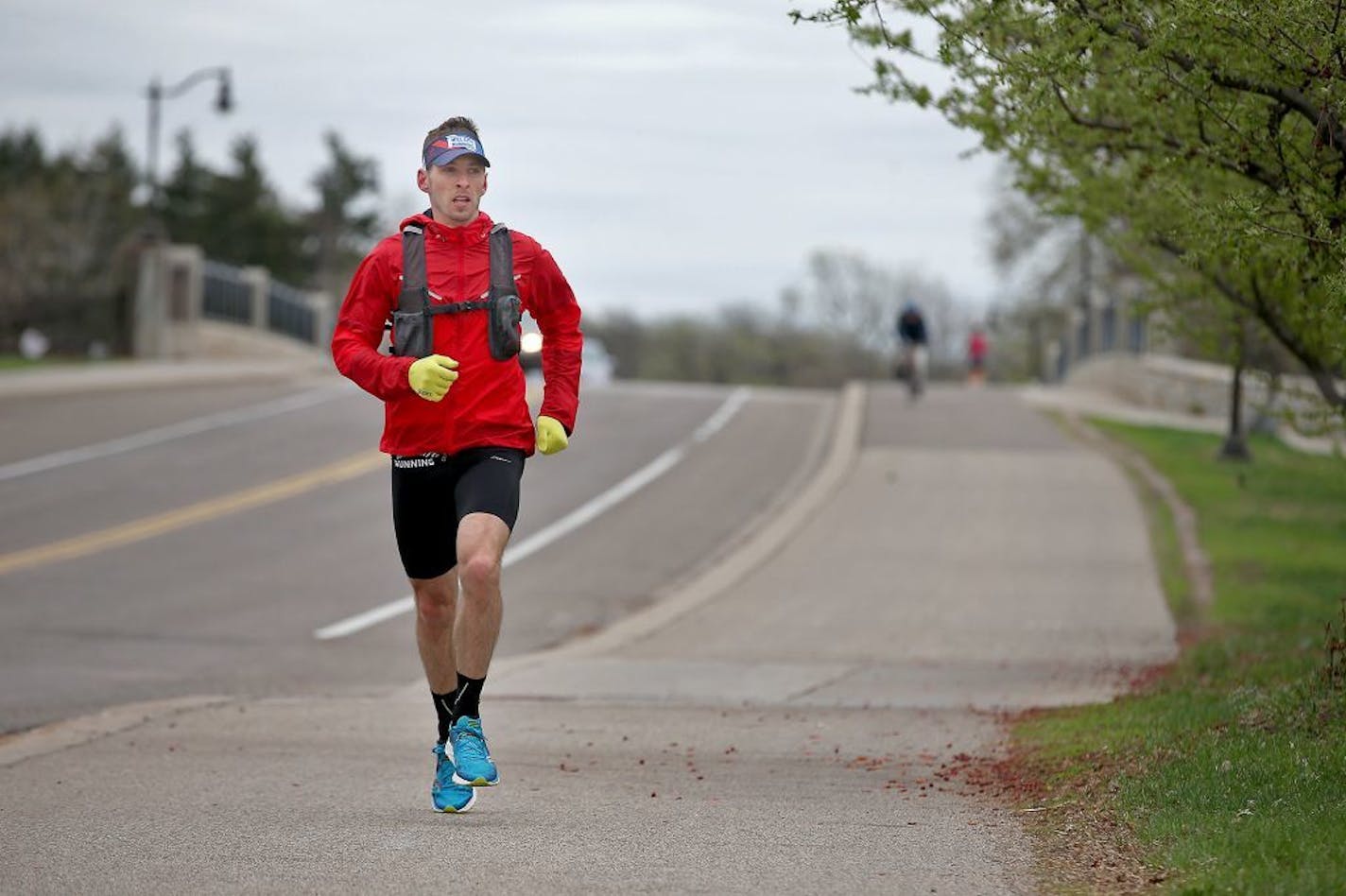 Jeff Metzdorff, co-owner of Mill City Running in Northeast Minneapolis, made his way on E. River Road on a 9-mile trek to his business from his home, Monday, April 20, 2015 in Minneapolis, MN. He is one of a growing number of runners who run to work.