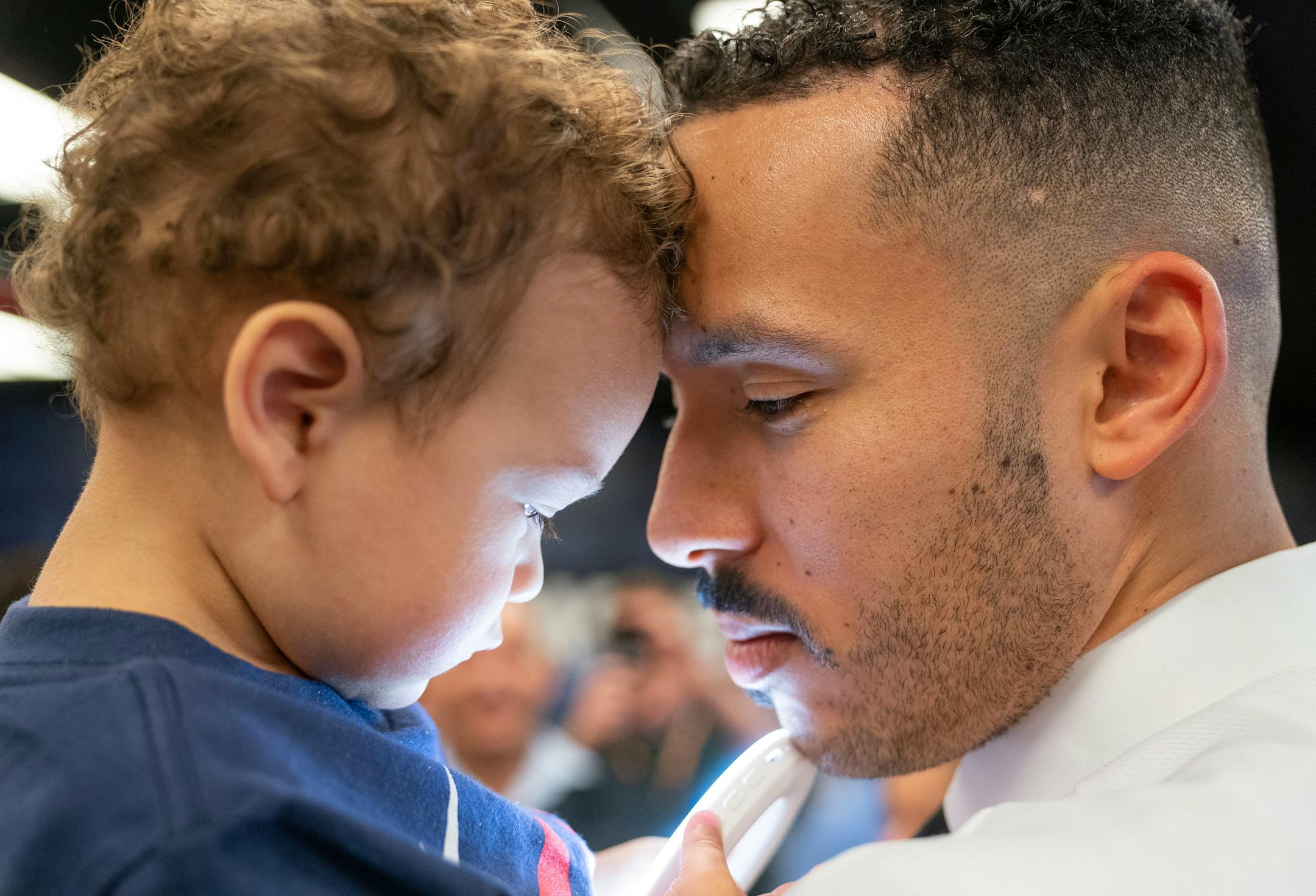 Minnesota Twins shortstop Carlos Correa embraces his son, Kylo, 1, after a press conference.
