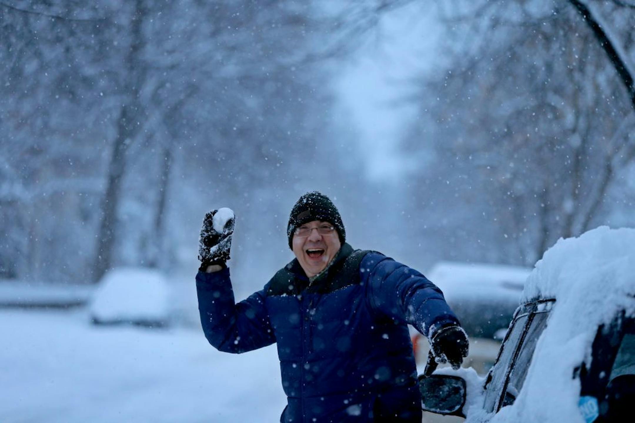 "You just have to have a good attitude about the snow," said John Stalzer as he made snowballs to try and hit his target in a tree in southwest Minneapolis, Friday, April 4, 2014.