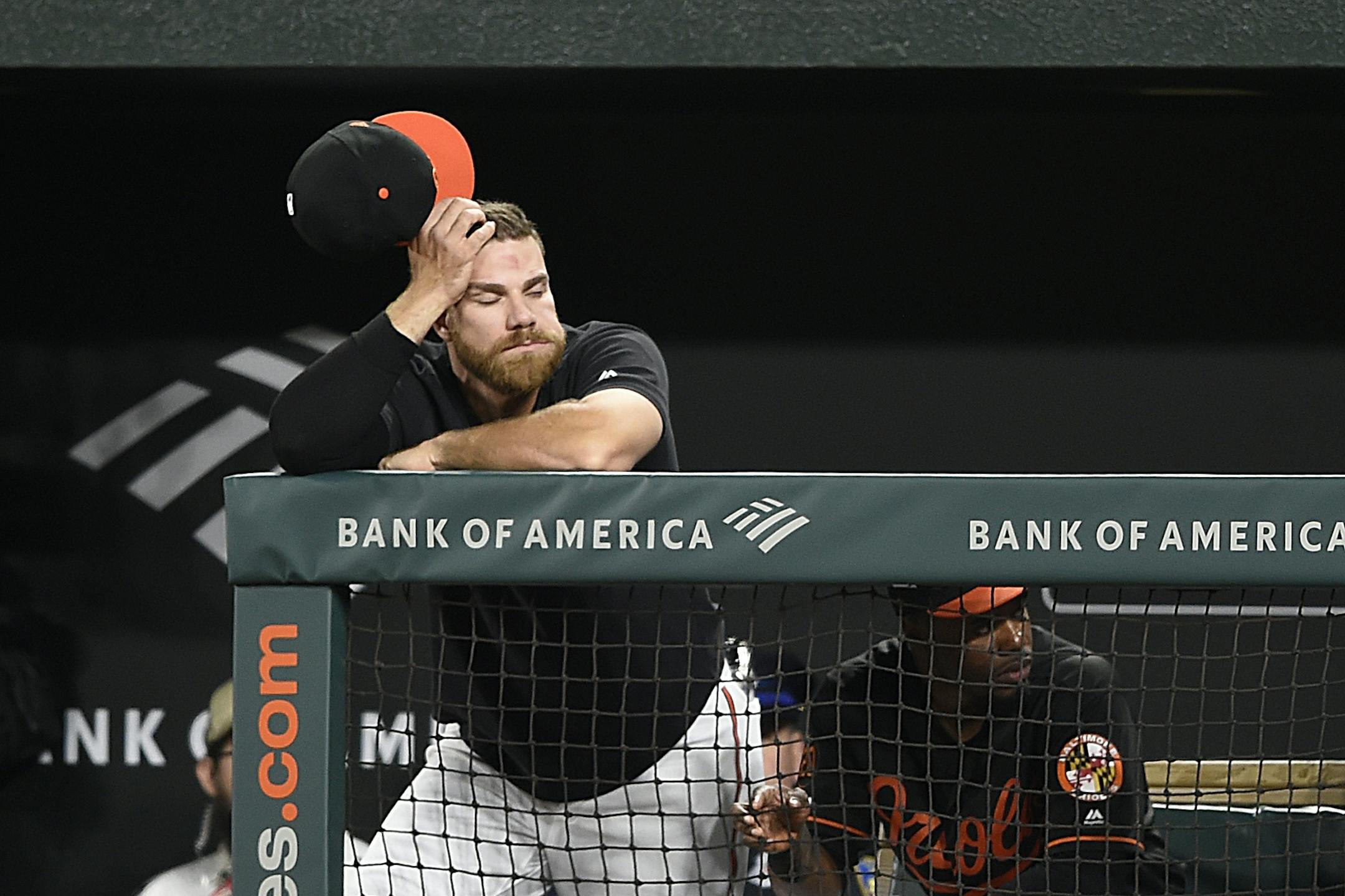 Baltimore Orioles' Chris Davis stands in the dugout in the fourth inning of the second game of a baseball doubleheader against the Minnesota Twins, Saturday, April 20, 2019, in Baltimore.