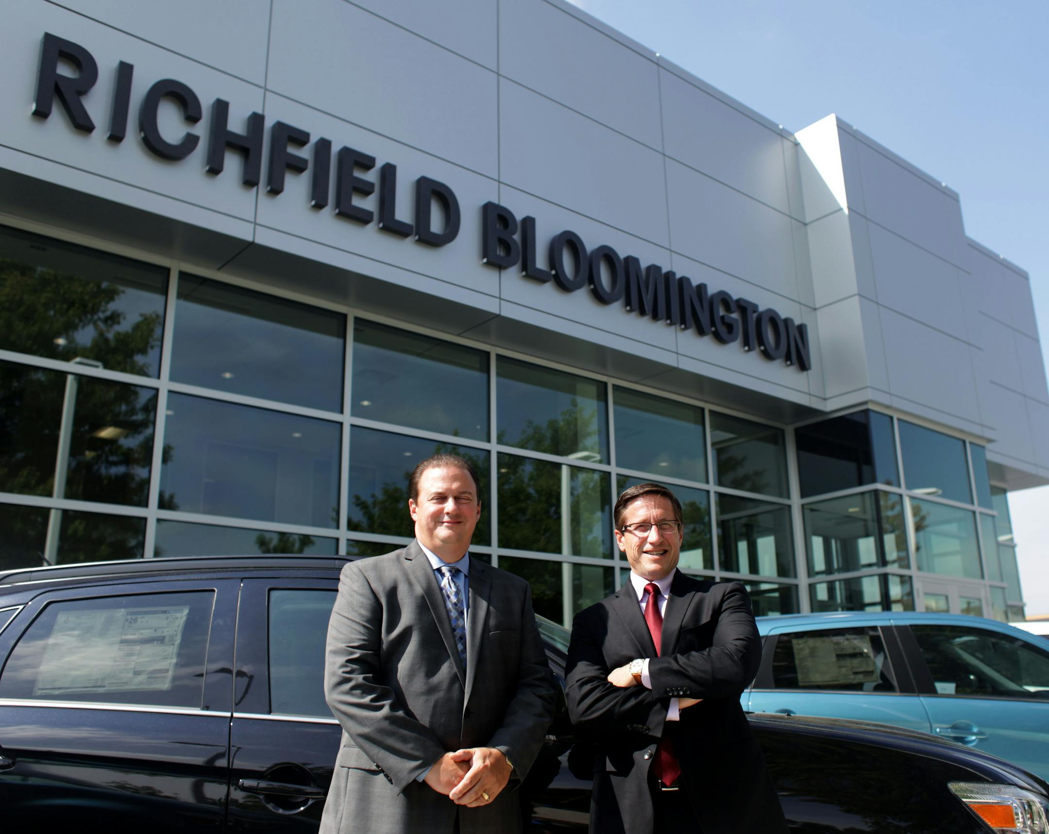Brent Wade, general manager of Richfield Bloomington Mitsubishi, and Tim Carter, general manager of Richfield Bloomington Honda, pose for a portrait in front of Richfield Bloomington Mitsubishi on Tuesday morning. ] MONICA HERNDON monica.herndon@startribune.com Richfield, MN 08/05/14